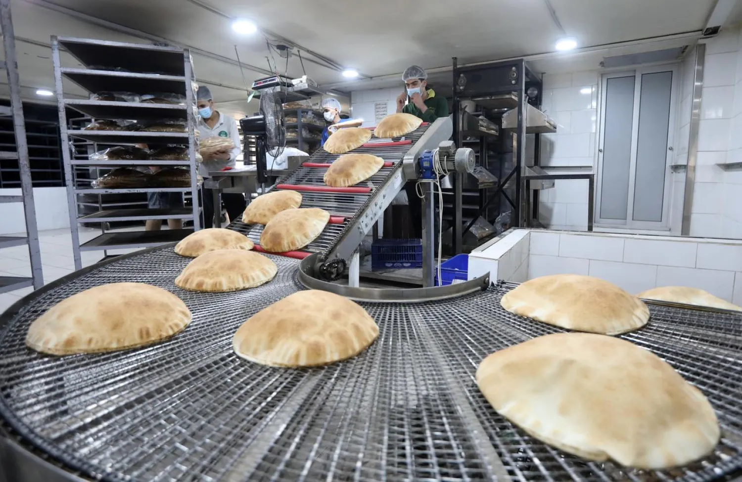 Workers pack freshly baked bread at a bakery in Beirut, following Tuesday's blast in Beirut's port area, Lebanon August 5, 2020. REUTERS/Mohamed Azakir
