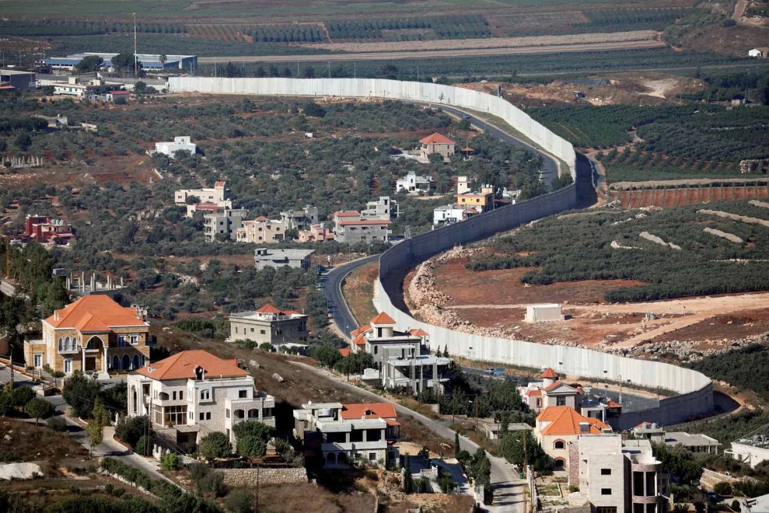 FILE PHOTO: A general view shows the Lebanese village of Adaisseh on the left-hand-side of the Israel-Lebanon border, as seen from Kibbutz Misgav Am in northern Israel August 26, 2019. REUTERS/Amir Cohen/File Photo