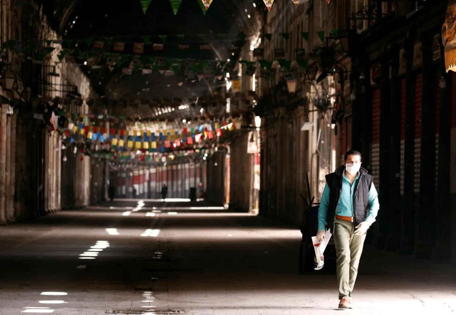 A man walks in empty Souk al-Hamidieh as restrictions are imposed as measure to prevent the spread of the coronavirus disease (COVID-19) in Damascus, Syria March 24, 2020. REUTERS/Omar Sanadiki