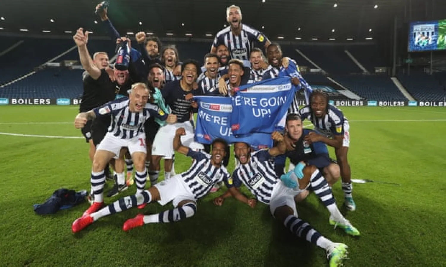  West Brom players and staff celebrate promotion to the Premier League at the end of their match with QPR. Photograph: Adam Fradgley - AMA/West Bromwich Albion FC/Getty Images
