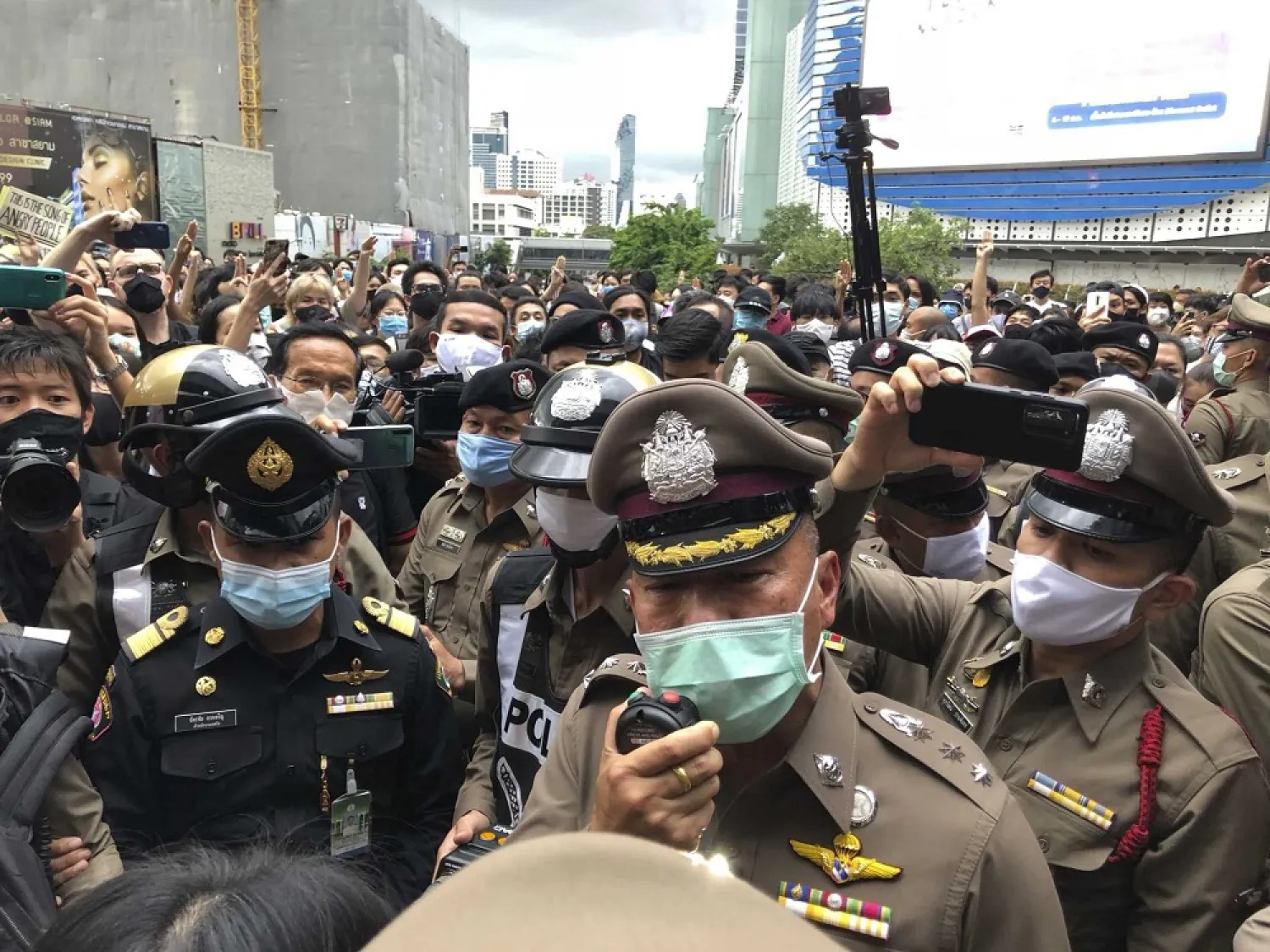 A police officer tries to speak to a crowd at an anti-government gathering Saturday, Aug. 8, 2020, in Bangkok, Thailand. (AP)
