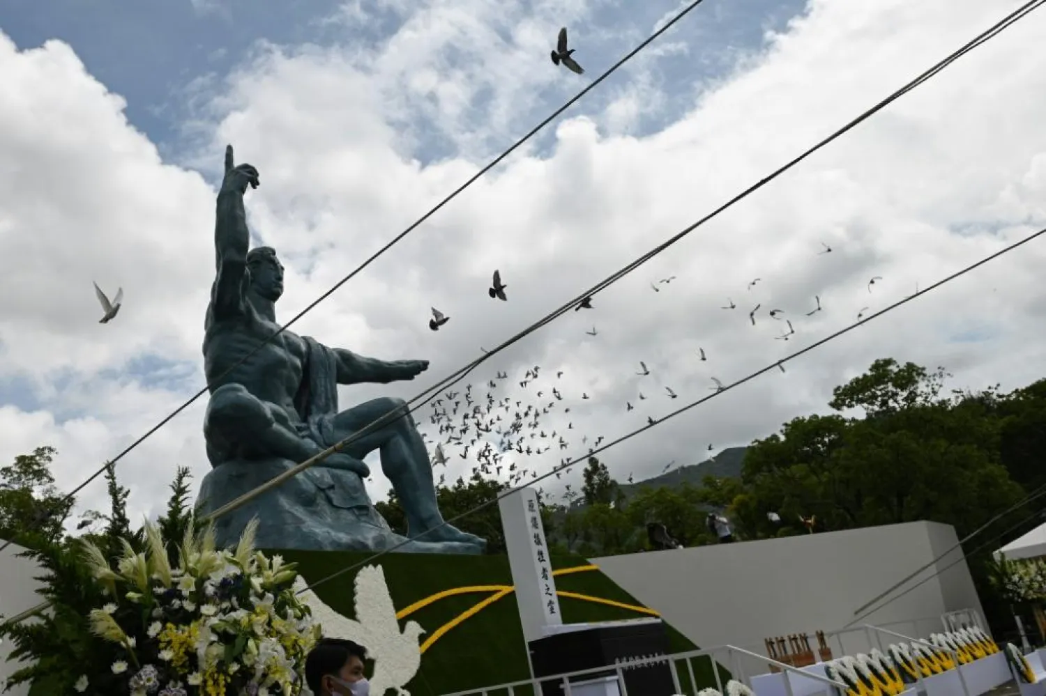 Doves fly during a ceremony marking the 75th anniversary of the atomic bombing of Nagasaki, at the city's Peace Park | AFP