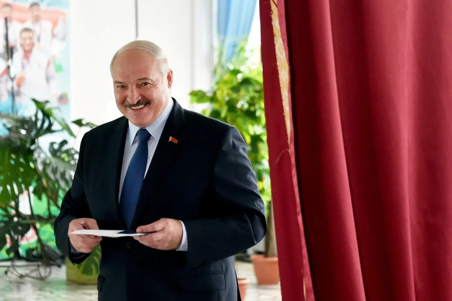 Belarusian President Alexander Lukashenko reacts as he visits a polling station in Minsk. (Reuters)