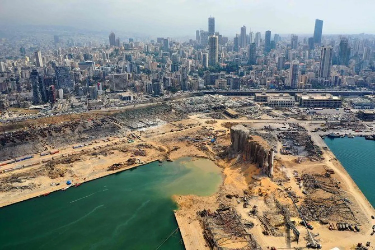 An aerial view taken on August 7, 2020 shows a partial view of the port of Beirut and the crater caused by the explosion. AFP