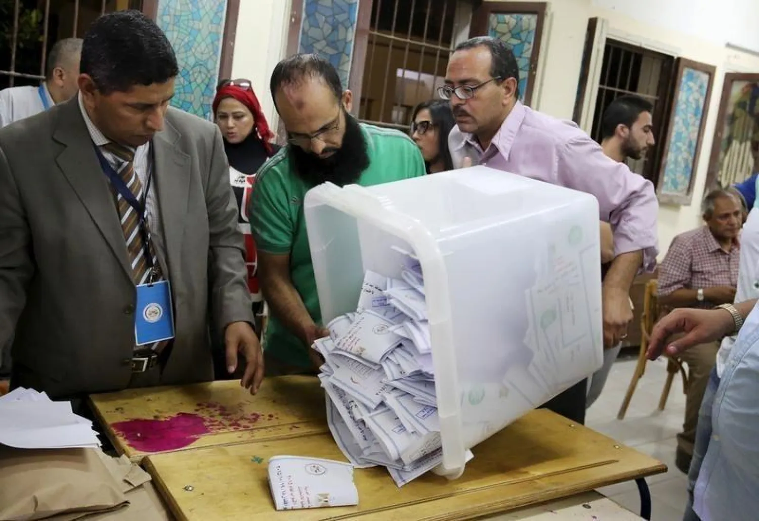 Employees count ballots after polls closed in the first phase of parliamentary elections (Reuters)
