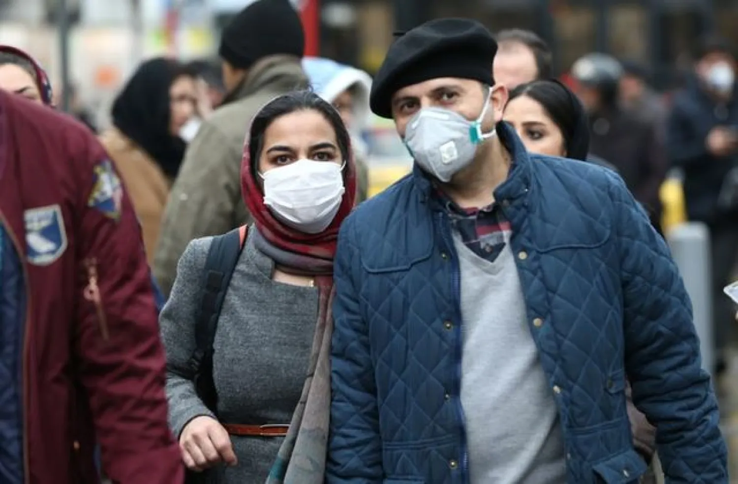 Iranian couple wearing protective masks to prevent contracting a coronavirus walk at Grand Bazaar in Tehran, Iran February 20, 2020. WANA (West Asia News Agency)/Nazanin Tabatabaee via REUTERSREUTERS