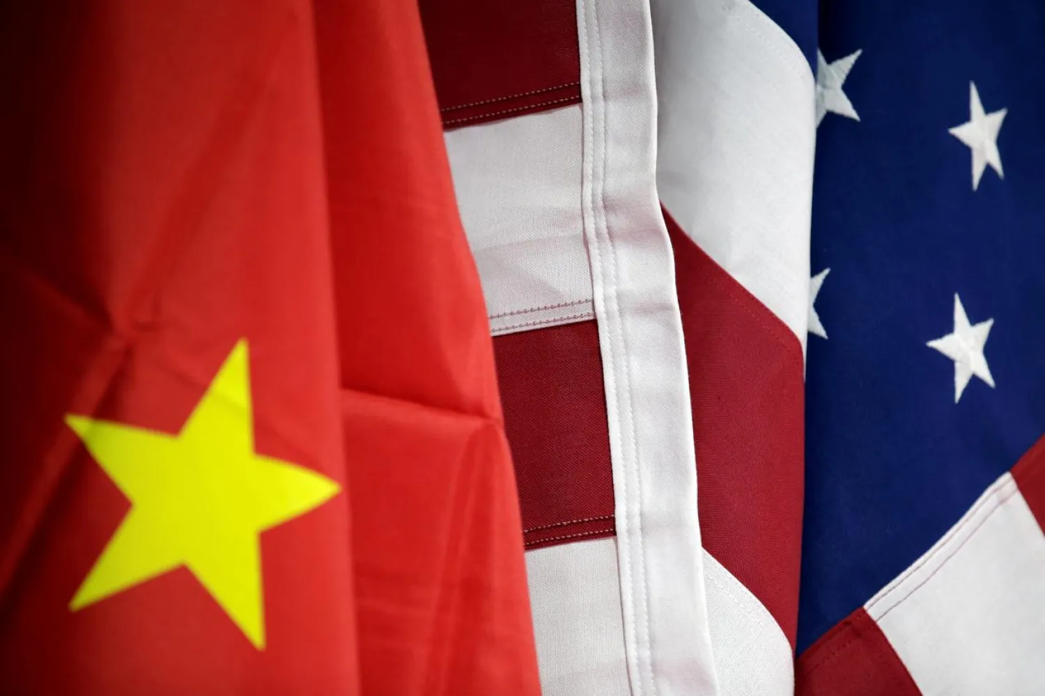 FILE PHOTO: Flags of US and China are displayed at American International Chamber of Commerce (AICC)'s booth during China International Fair for Trade in Services in Beijing, China, May 28, 2019. REUTERS/Jason Lee/File Photo