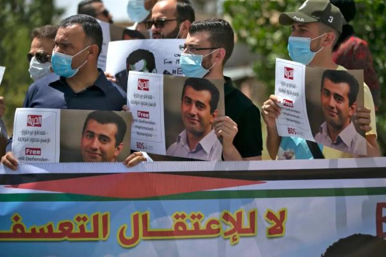 Palestinians protest against the detention by Israel of BDS campaigner Mahmoud Nawajaa on August 11, 2020 in the city of Ramallah. (AFP)