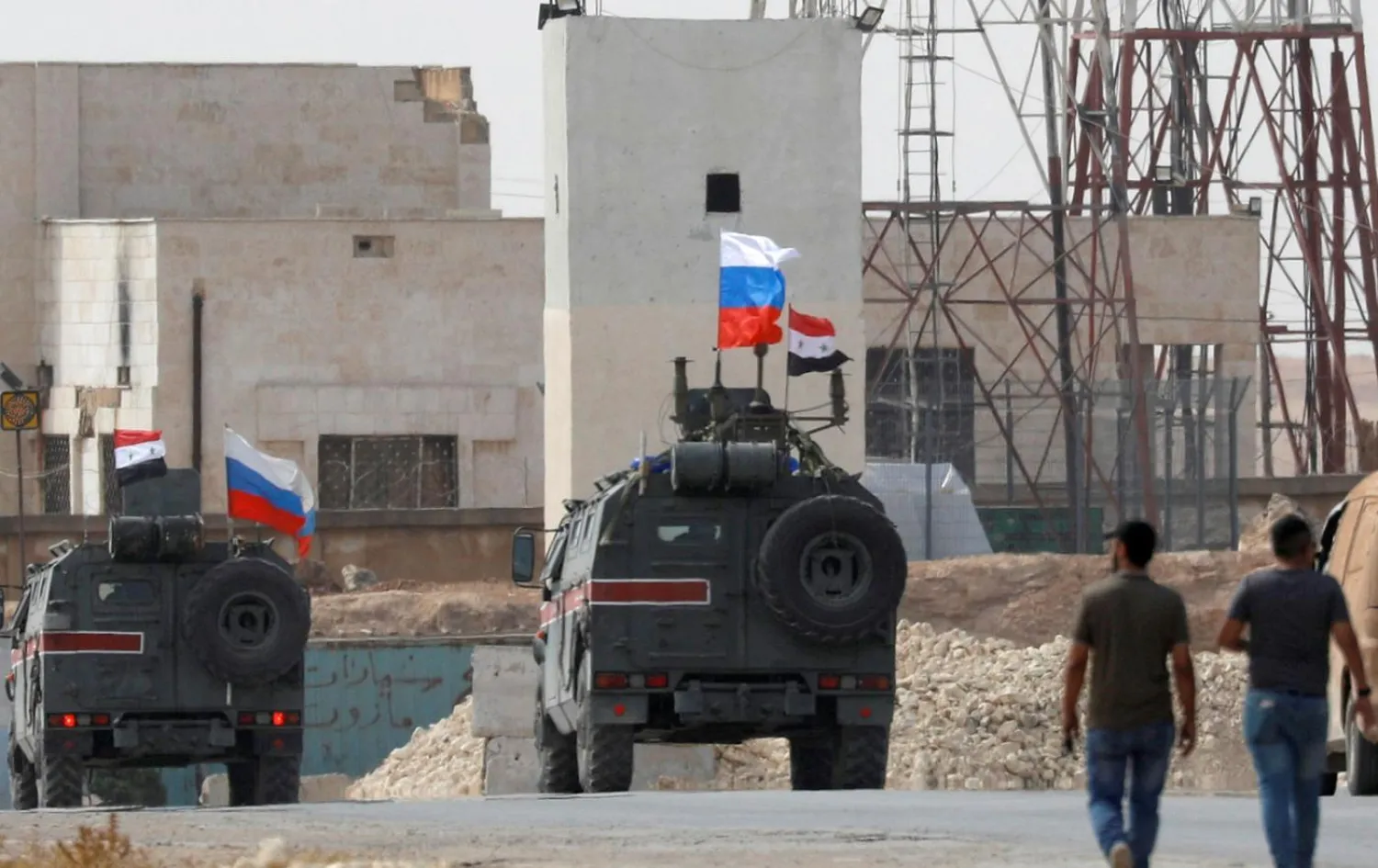 Russian flags on military vehicles near Manbij, in northern Syria on 15 October (Reuters)