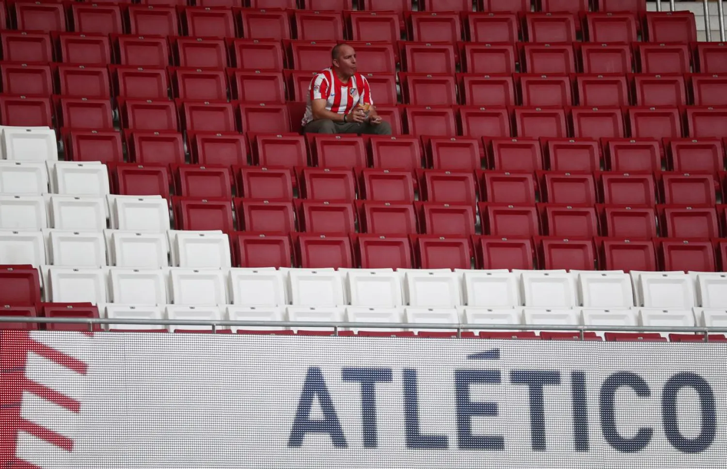 FILE PHOTO: Soccer Football - La Liga Santander - Atletico Madrid v Real Madrid - Wanda Metropolitano, Madrid, Spain - September 28, 2019 An Atletico Madrid fan inside the stadium before the match REUTERS/Sergio Perez