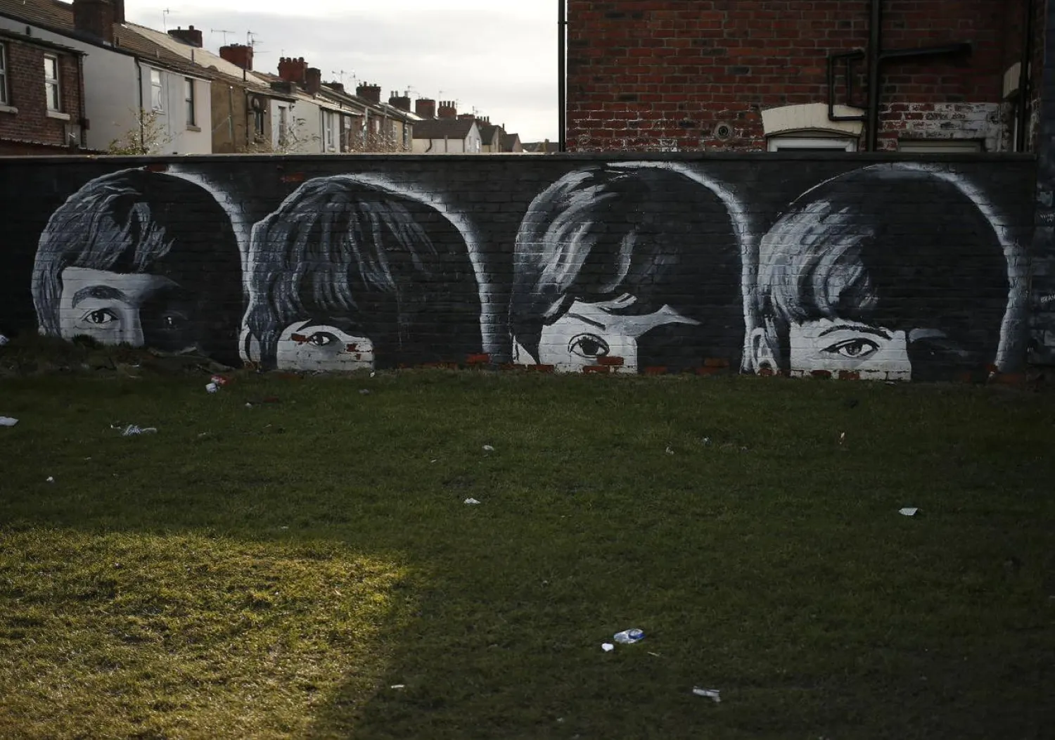 A mural of the Beatles is seen painted on the end of a row of terraced houses in Liverpool, northern England February 18, 2015. REUTERS/Phil Noble/Files