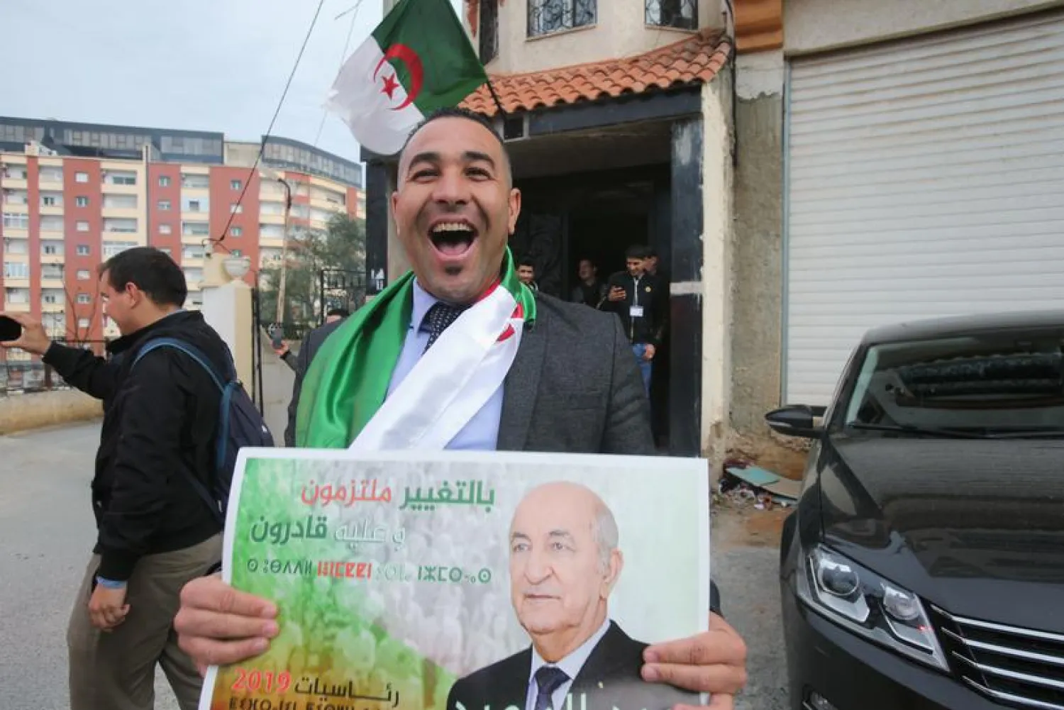 Supporter reacts at the campaign headquarters of Abdelmadjid Tebboune after he was announced as the new president, in Algiers, Algeria December 13, 2019. REUTERS/Ramzi Boudina