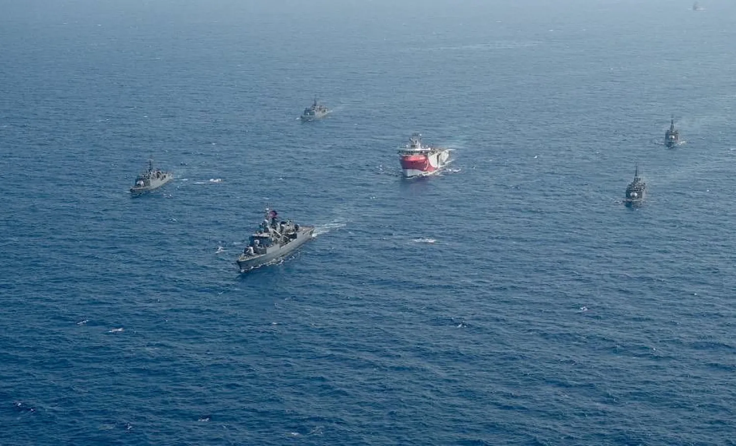In this taken Monday, Aug. 10, 2020, Turkey's research vessel, Oruc Reis, center, is surrounded by Turkish navy vessels as it was heading in the west of Antalya on the Mediterranean, Turkey.  (IHA via AP)
