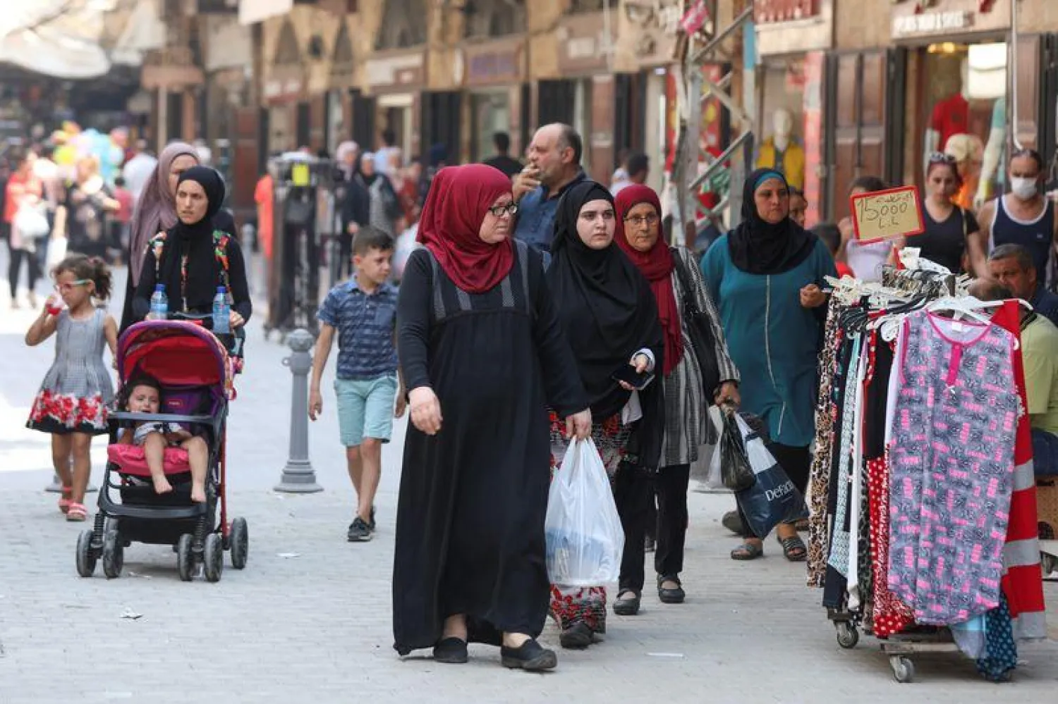 People walk at a souk ahead of the Eid al-Adha celebrations in Tripoli, northern Lebanon July 29, 2020. REUTERS/Mohamed Azakir
