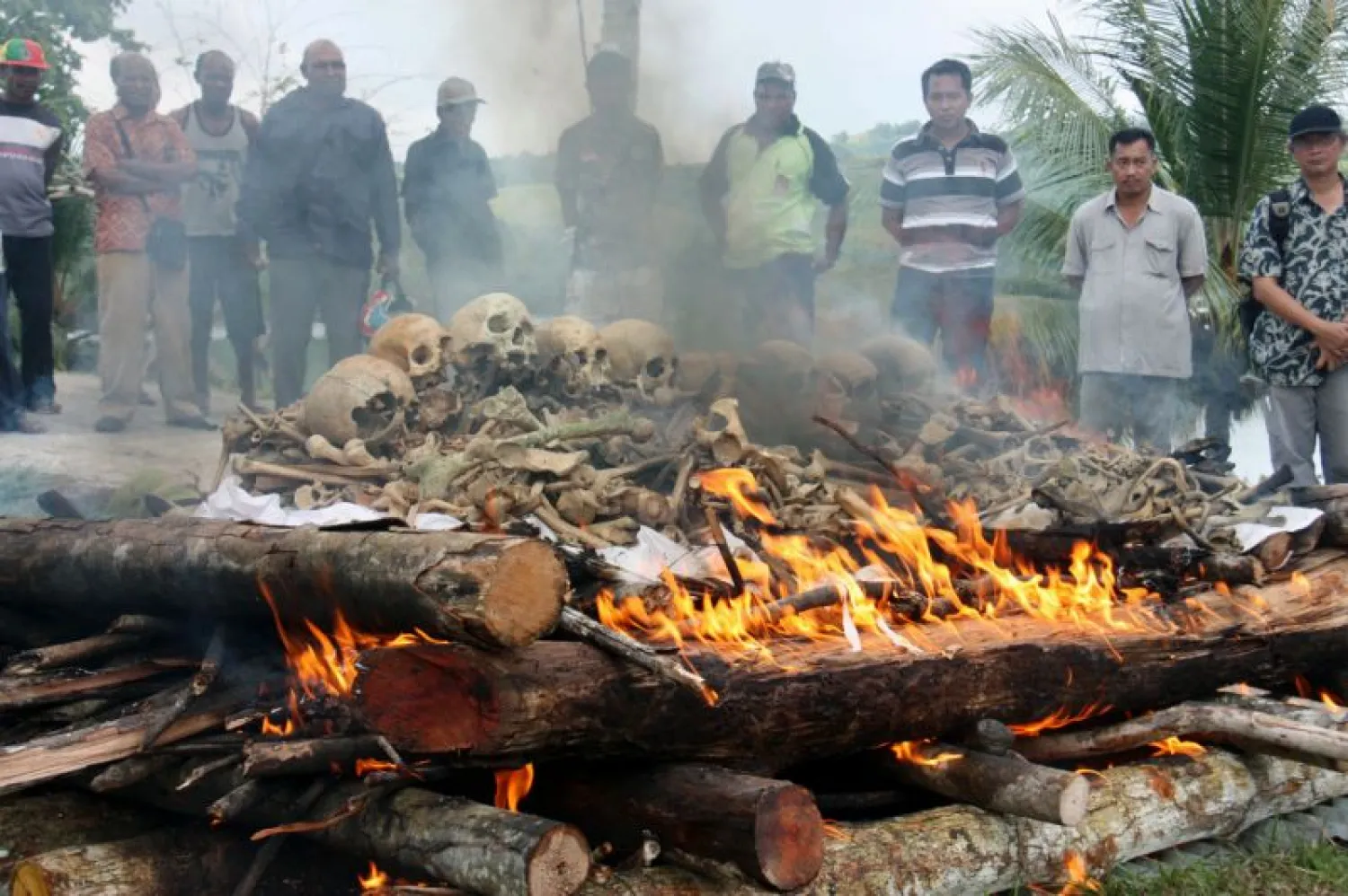 People gather for the cremation ceremony for Japanese war dead in World War II, in Papua province, Indonesia, March, 2013. Seventy-five years after the end of World War II, more than 1 million Japanese war dead are scattered throughout Asia, where the legacy of Japanese aggression still hampers recovery efforts. The missing Japanese make up about half of the 2.4 million soldiers who died overseas during Japan's military rampage across Asia in the early 20th century. (Kyodo News via AP)