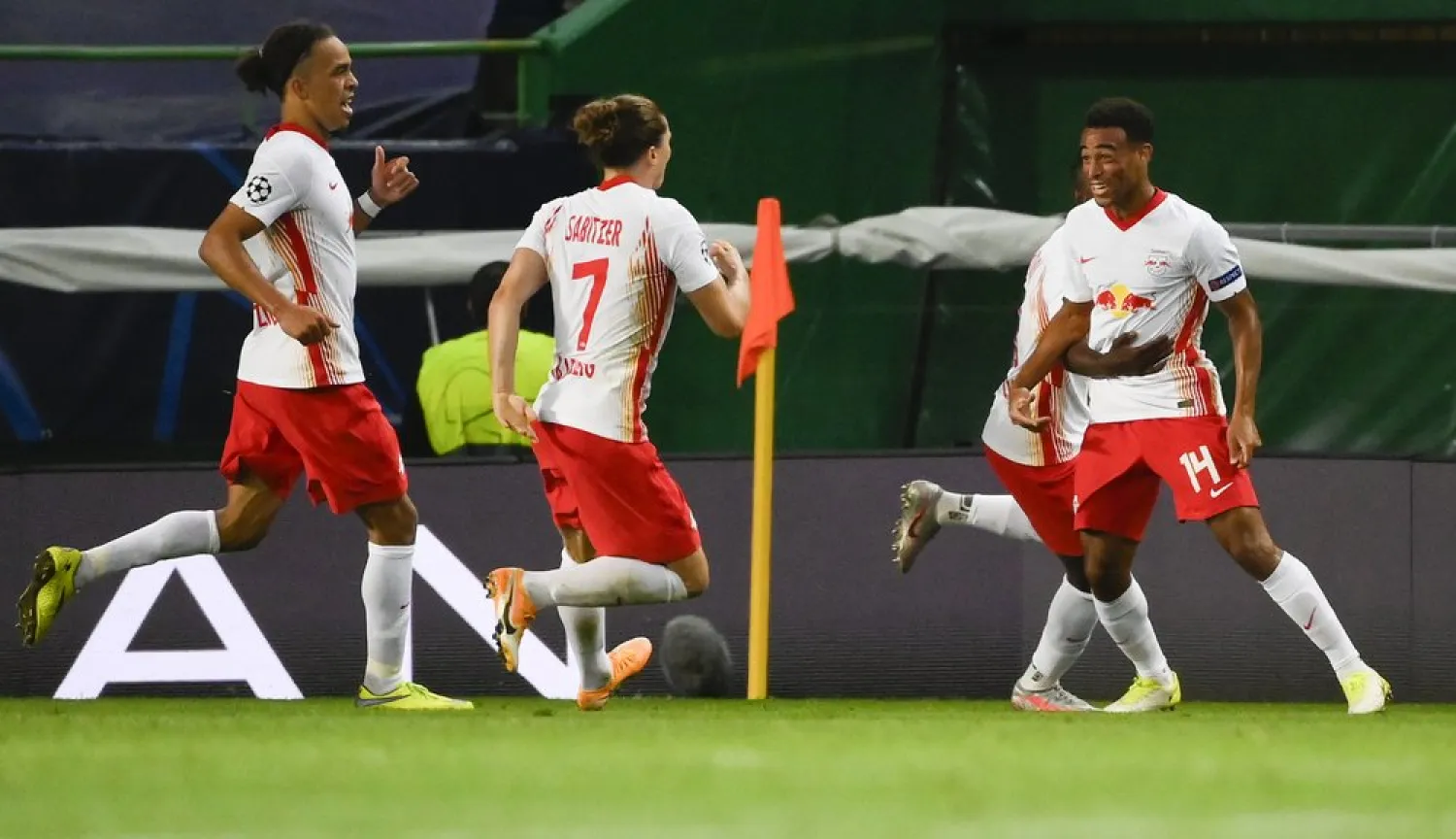 Leipzig's Tyler Adams, right, celebrates after scoring his team's second goal during the Champions League quarterfinal against Atletico Madrid in Lisbon, Portugal, Aug. 13, 2020. (AP)