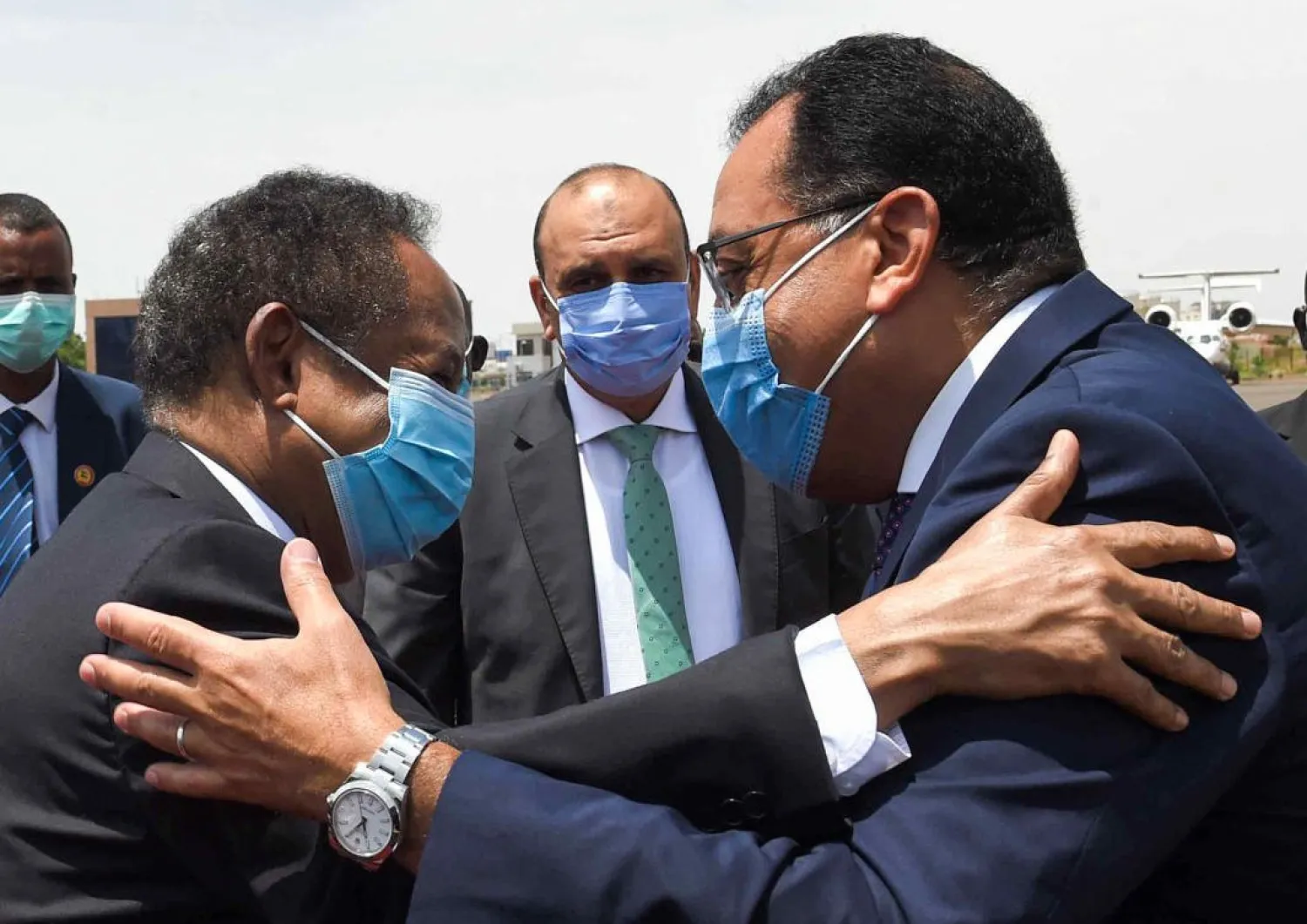 PM Mostafa Madbouli (R) being embraced by Sudan's PM Abdalla Hamdok (L) at the capital's Khartoum International Airport. (AFP)
