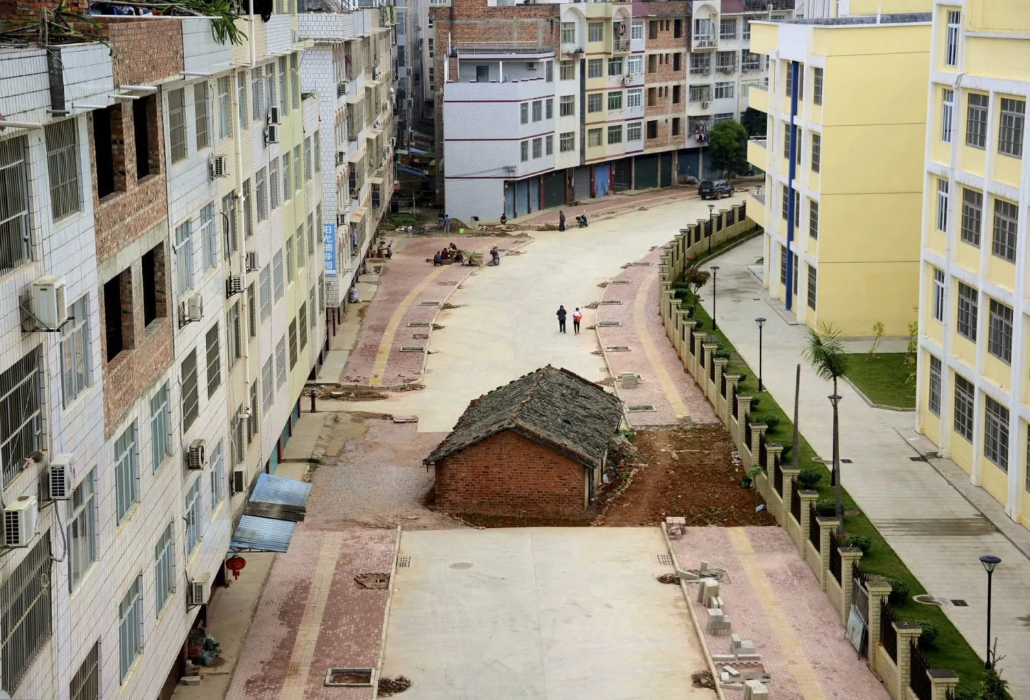 A nail house sits in the middle of a road under construction in
Nanning in April 2015.  Photograph: China Stringer Network/Reuters