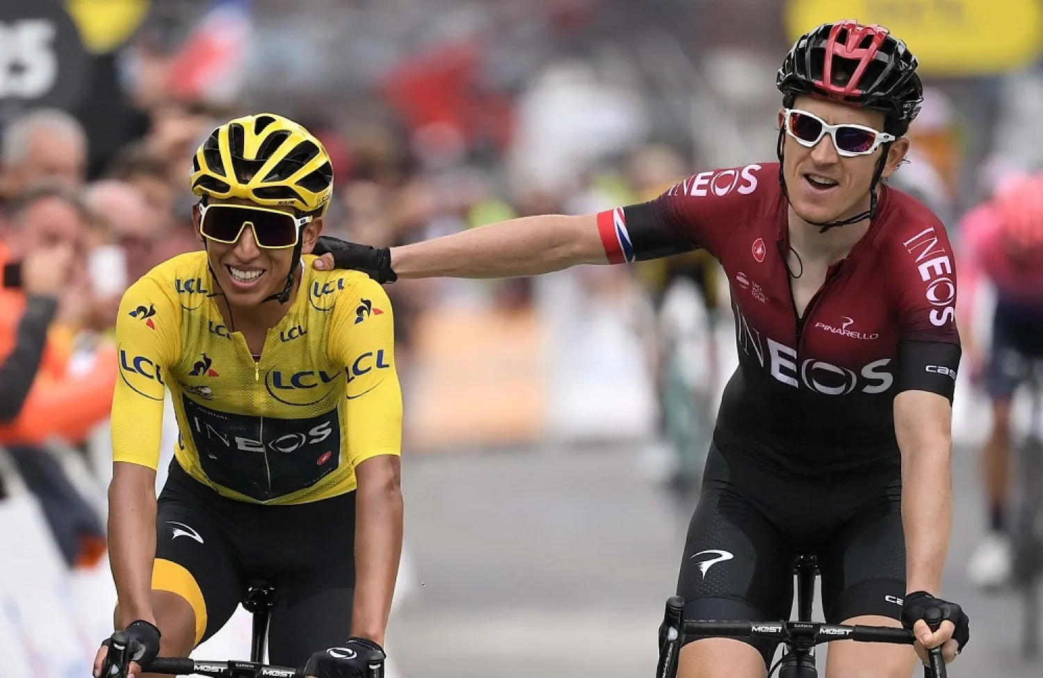 Colombia’s Egan Bernal is congratulated by teammate Britain’s Geraint Thomas as he crosses the finish line of the 20th stage of the 106th edition of the Tour de France. (Getty Images)