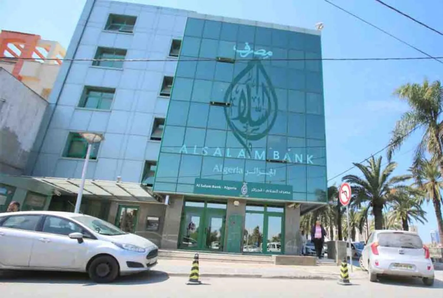 Looming trouble. A man walks outside Al Salam Bank in Algiers. (Reuters)
