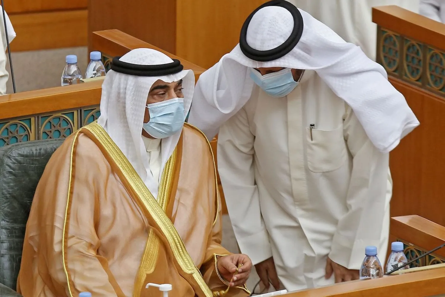 Kuwaiti Prime Minister Sheikh Sabah al-Khaled al-Sabah (L) talks with Kuwait’s Finance Minister Barak al-Shitan, during a parliament session at Kuwait's national assembly in Kuwait City on 12 August 2020. [YASSER AL-ZAYYAT/AFP via Getty Images]
