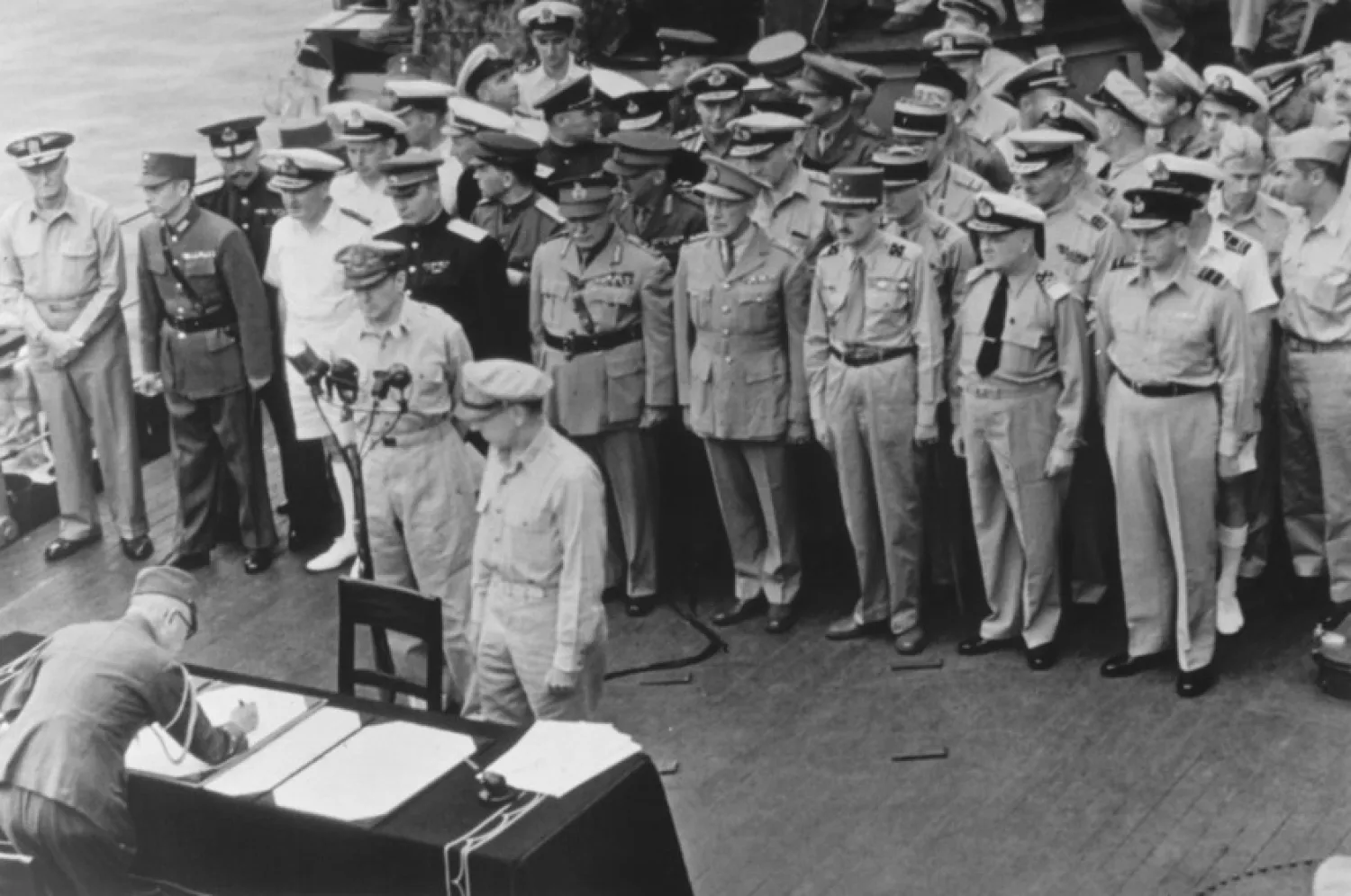 General of the Army Douglas MacArthur, Supreme Allied Commander, and General Wainwright, who surrendered to the Japanese after Bataan and Corregidor, witness the formal Japanese surrender signatures aboard the USS Missouri in Tokyo Bay on Sept. 2, 1945. (AP Photo, File)