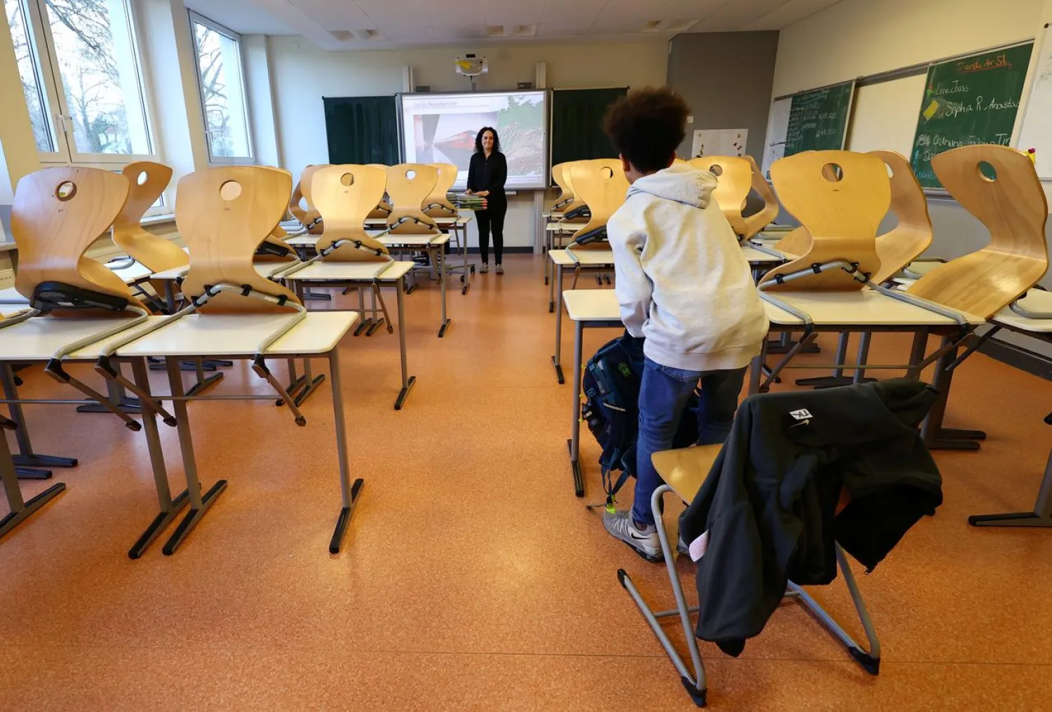 Geography teacher Dinar Pamukci looks at the last student leaving her classroom at Hesse's largest high school, Karl-Rehbein-Schule, in Hanau, after authorities decided to close schools in most of Germany's federal states due to the coronavirus disease (COVID-19) in Germany, March 13, 2020. REUTERS/Kai Pfaffenbach
