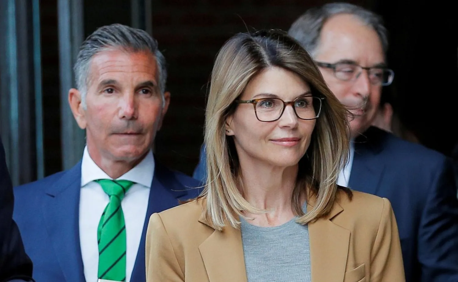 Fashion designer Mossimo Giannulli (L), actress Lori Loughlin’s (C) husband, was sentenced on to five months in prison for participating in a US college admissions scam. (Reuters)