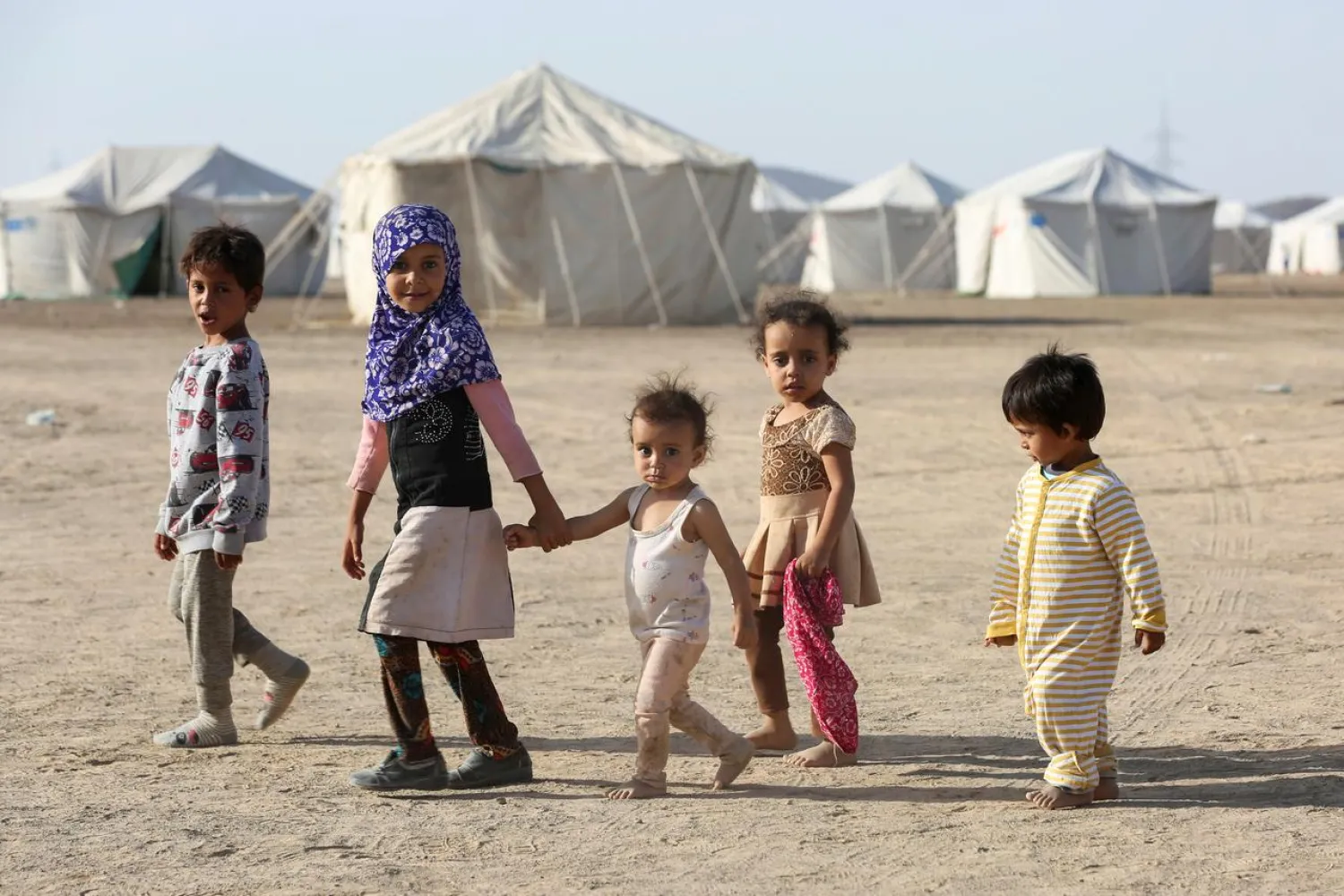 Children walk at a camp for people recently displaced by fighting in Yemen's northern province of al-Jawf between government forces and Houthis, in Marib, Yemen March 8, 2020. Picture taken March 8, 2020. REUTERS/Ali Owidha