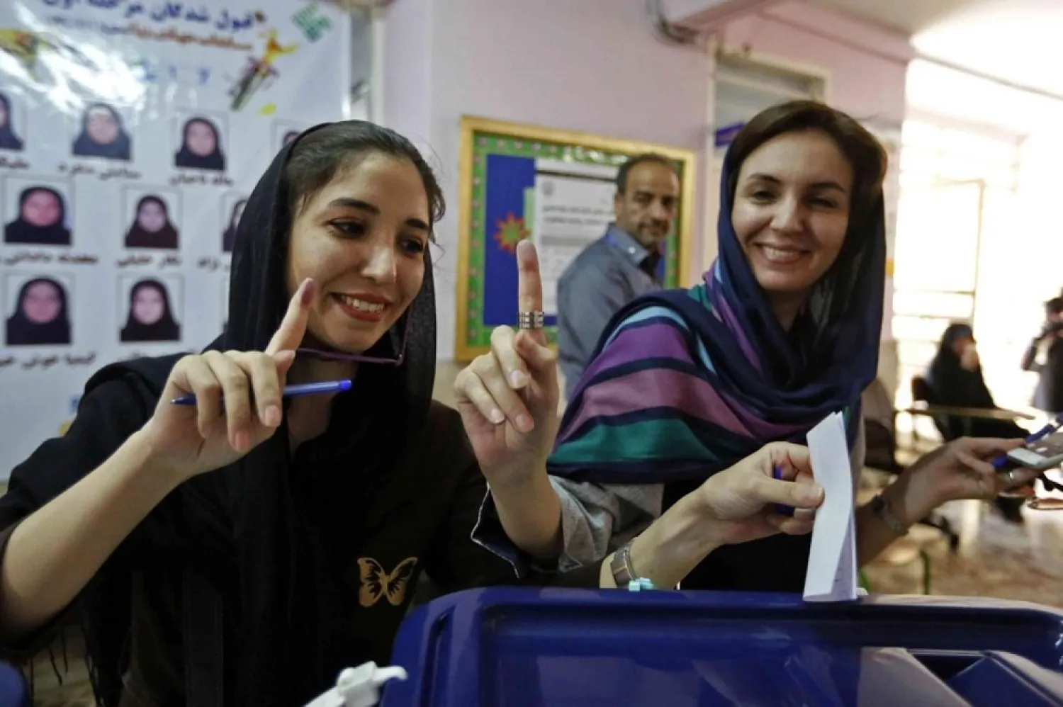 Iranian women cast their ballots for the presidential elections at a polling station north of Tehran on May 19, 2017. (AFP)