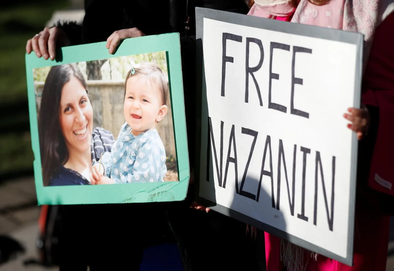 FILE PHOTO - Demonstrators hold placards before a march in support of Nazanin Zaghari-Ratcliffe, the British-Iranian mother who is in jail in Iran, in London, Britain, November 25, 2017. REUTERS/Peter Nicholls