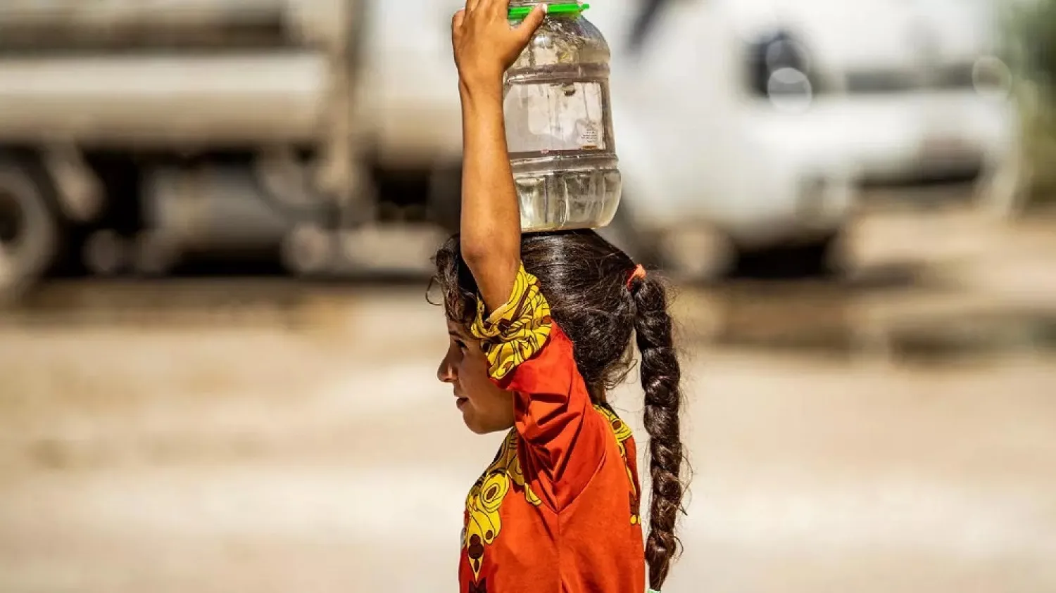 A Syrian girl brings water back to a camp for the displaced in the Kurdish run-city of Hasakeh in Syria's northeast. (AFP)