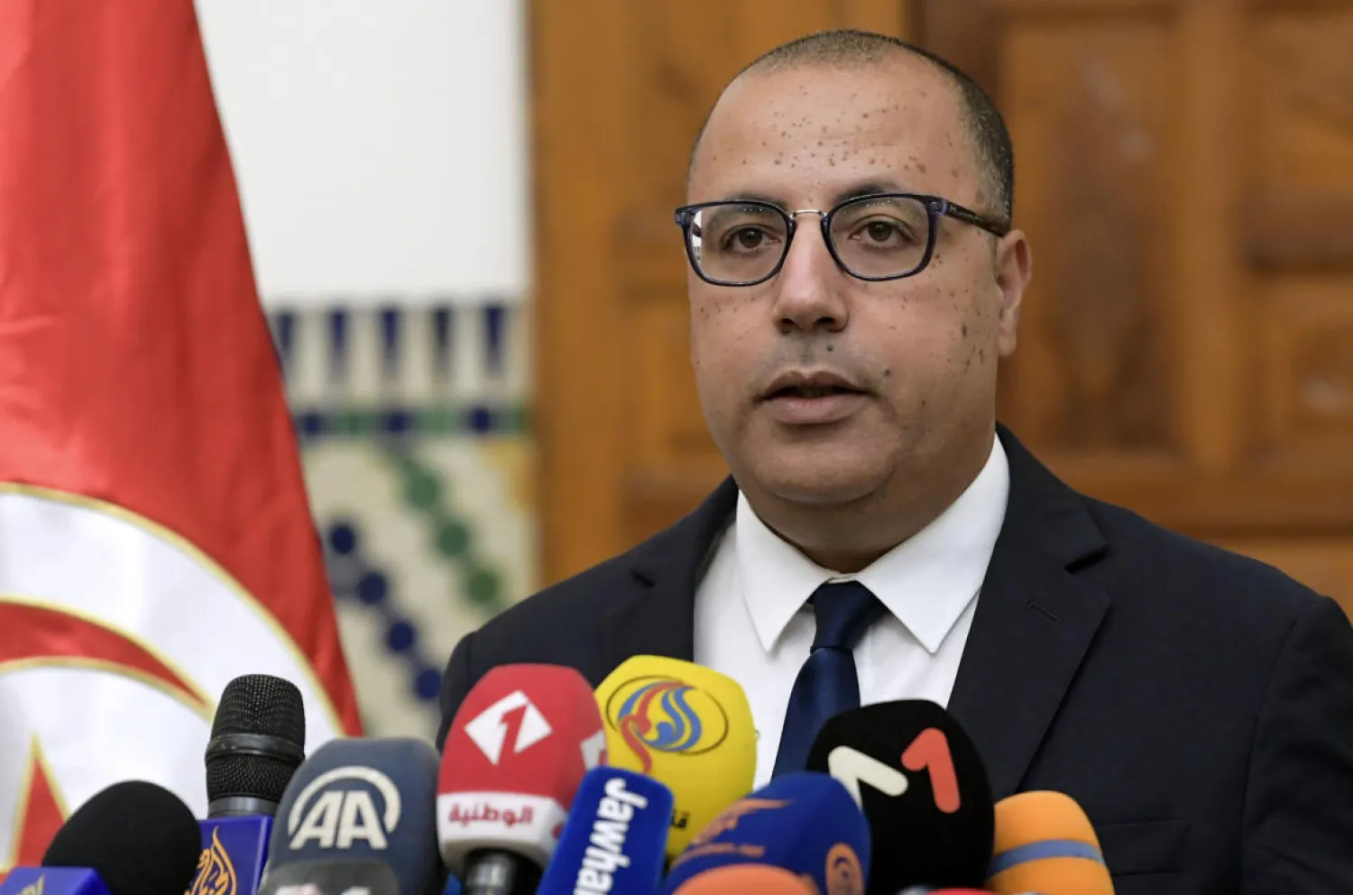 Tunisia's Prime Minister-designate Hichem Mechichi briefs the media about his proposed government list during a press conference in Carthage, on August 10, 2020. (AFP)