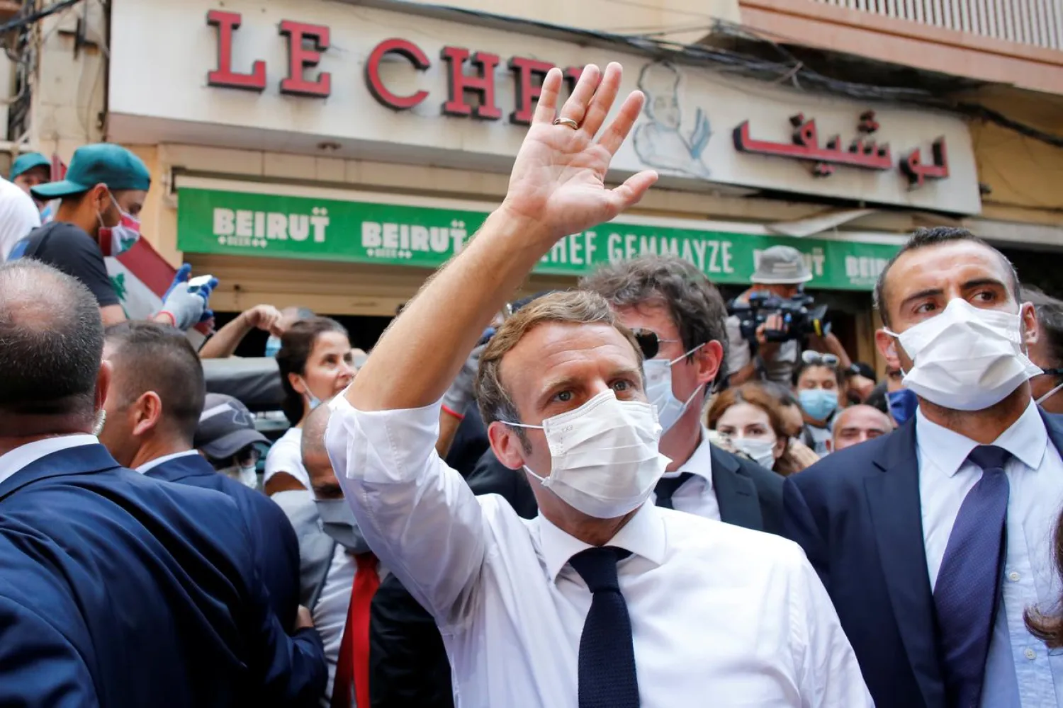 FILE PHOTO: French President Emmanuel Macron waves as he visits a devastated street of Beirut, Lebanon August 6, 2020. Thibault Camus/Pool via REUTERS