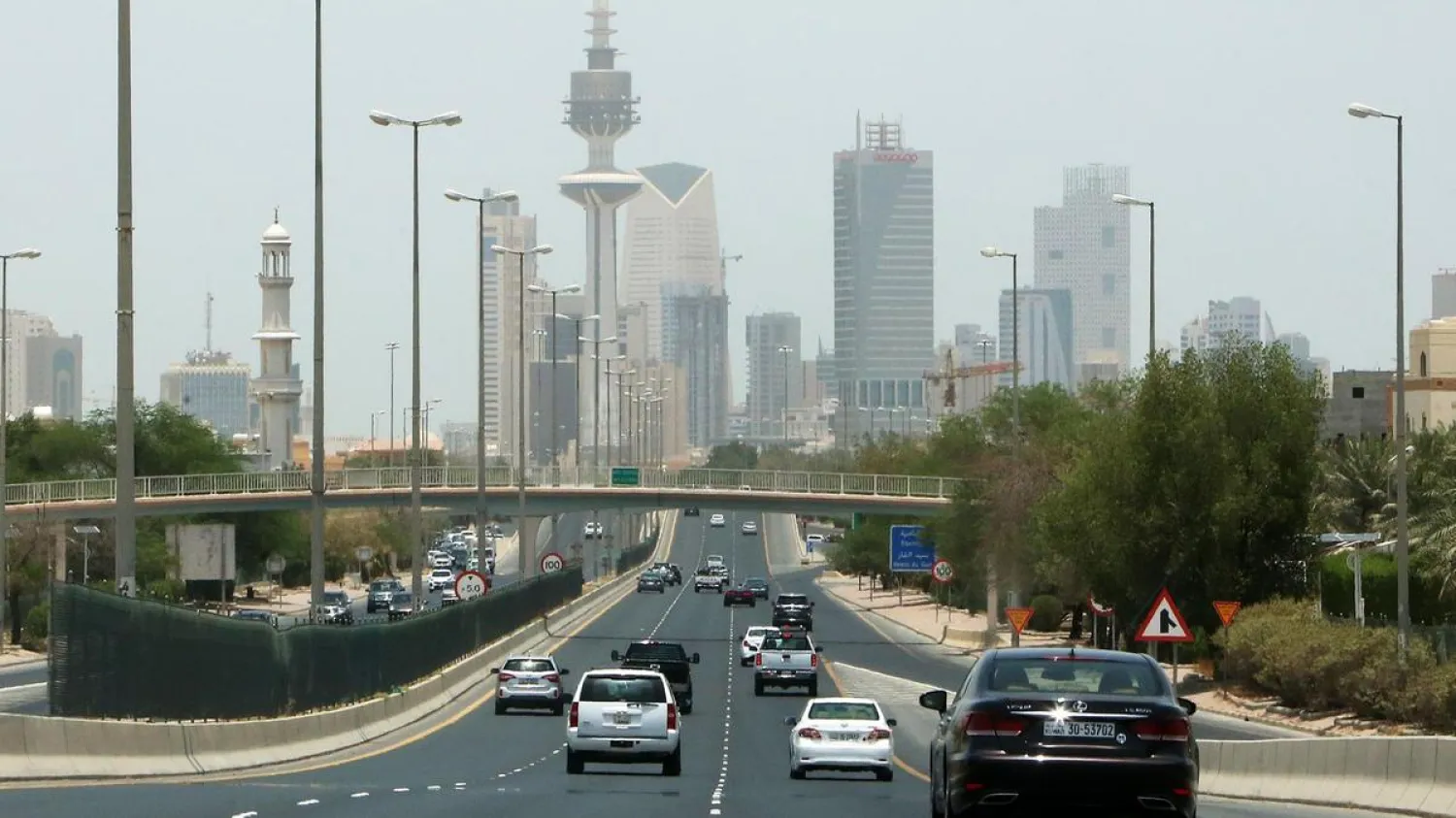 Vehicles drive down a highway in the Kuwaiti capital Kuwait City on May 31, 2020 after authorities eased some of the restrictions put in place because of the coronavirus pandemic. (AFP)