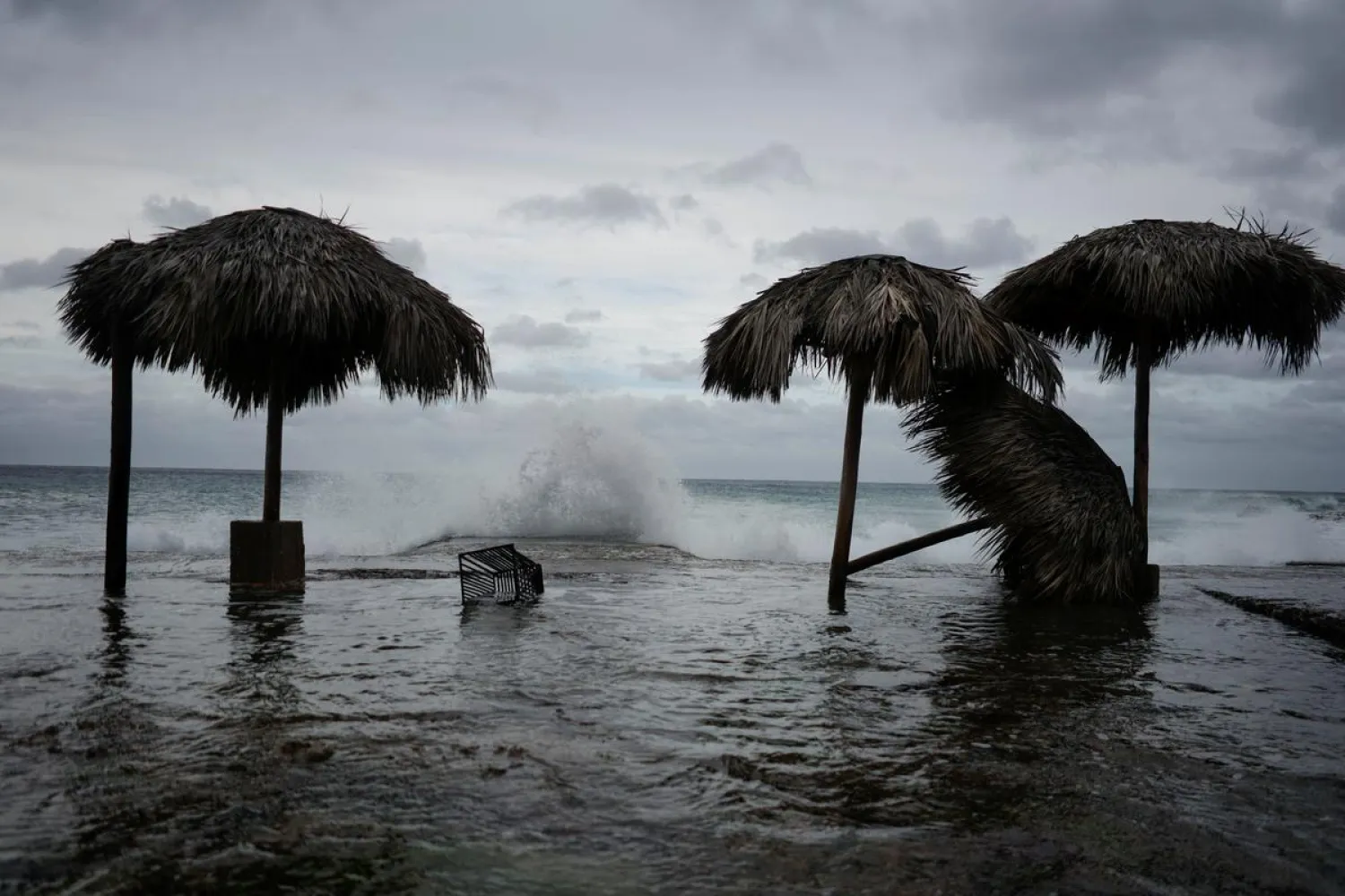 Waves splash during the passage of Tropical Storm Laura in Havana, Cuba, August 24, 2002. (Reuters)