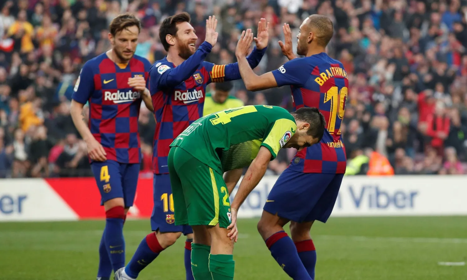 Martin Braithwaite celebrates with Messi after setting up Barcelona’s fourth goal in their 5-0 win over Eibar, having come off the bench to make his debut two days after joining the club in February. Photograph: Albert Gea/Reuters
