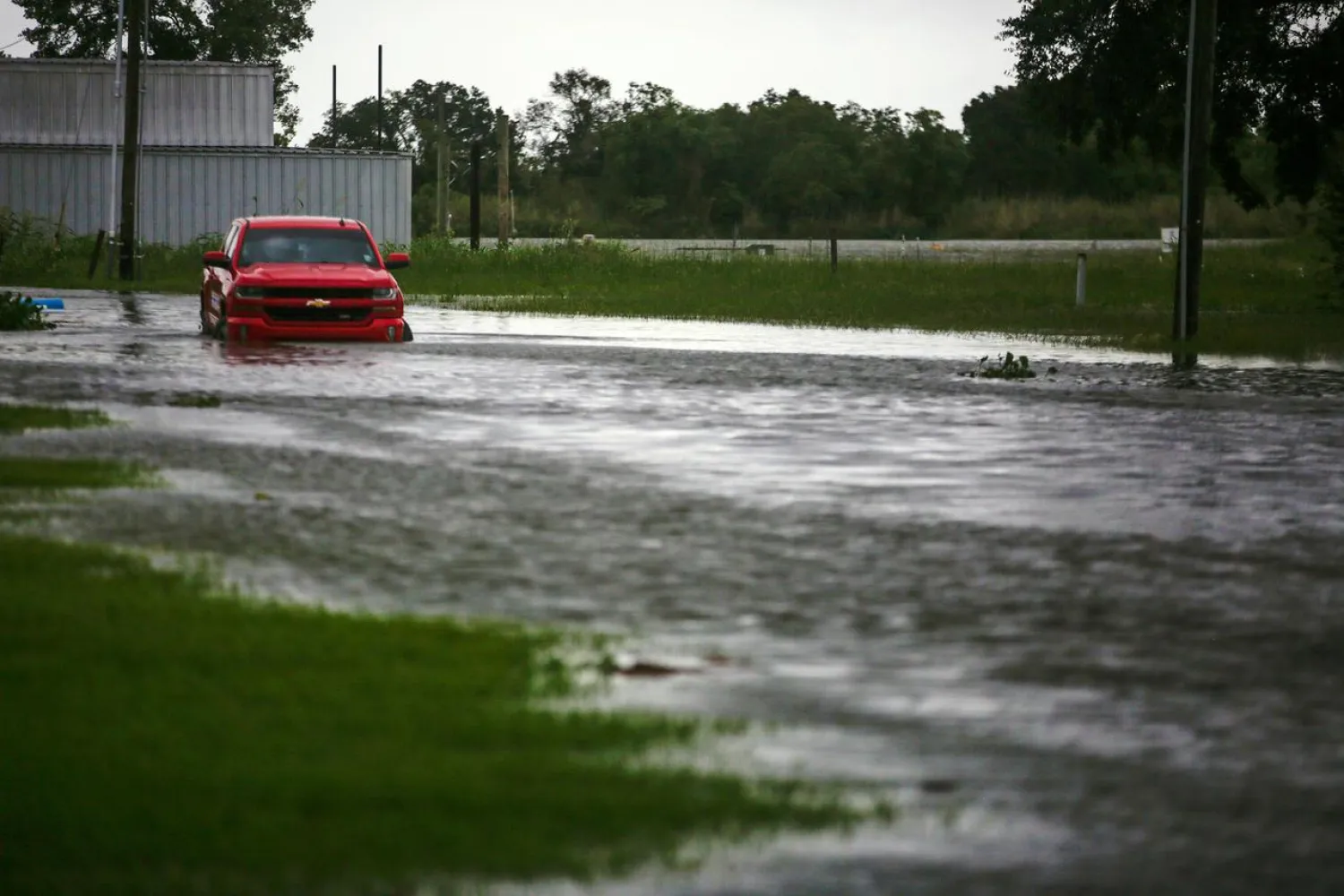 FILE PHOTO: A car near Vermilion Bay is seen partially submerged in waters brought by Hurricane Laura approaching Abbeville, Louisiana, US, August 26, 2020. REUTERS/Kathleen Flynn