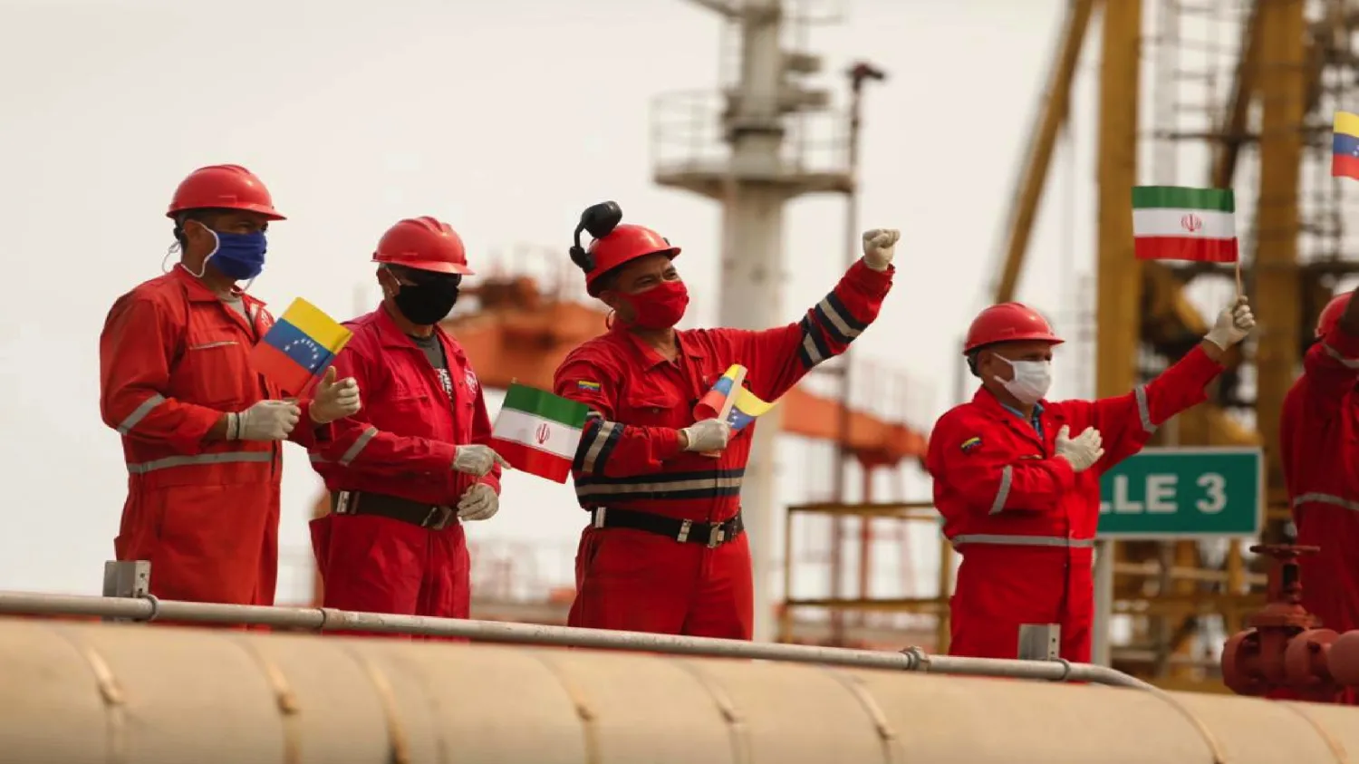 Workers of the state-oil company Pdvsa holding Iranian and Venezuelan flags greet during the arrival of the Iranian tanker ship Fortune at El Palito refinery in Puerto Cabello, Venezuela, May 25, 2020.  Photo by Miraflores Palace/Handout via REUTERS.
