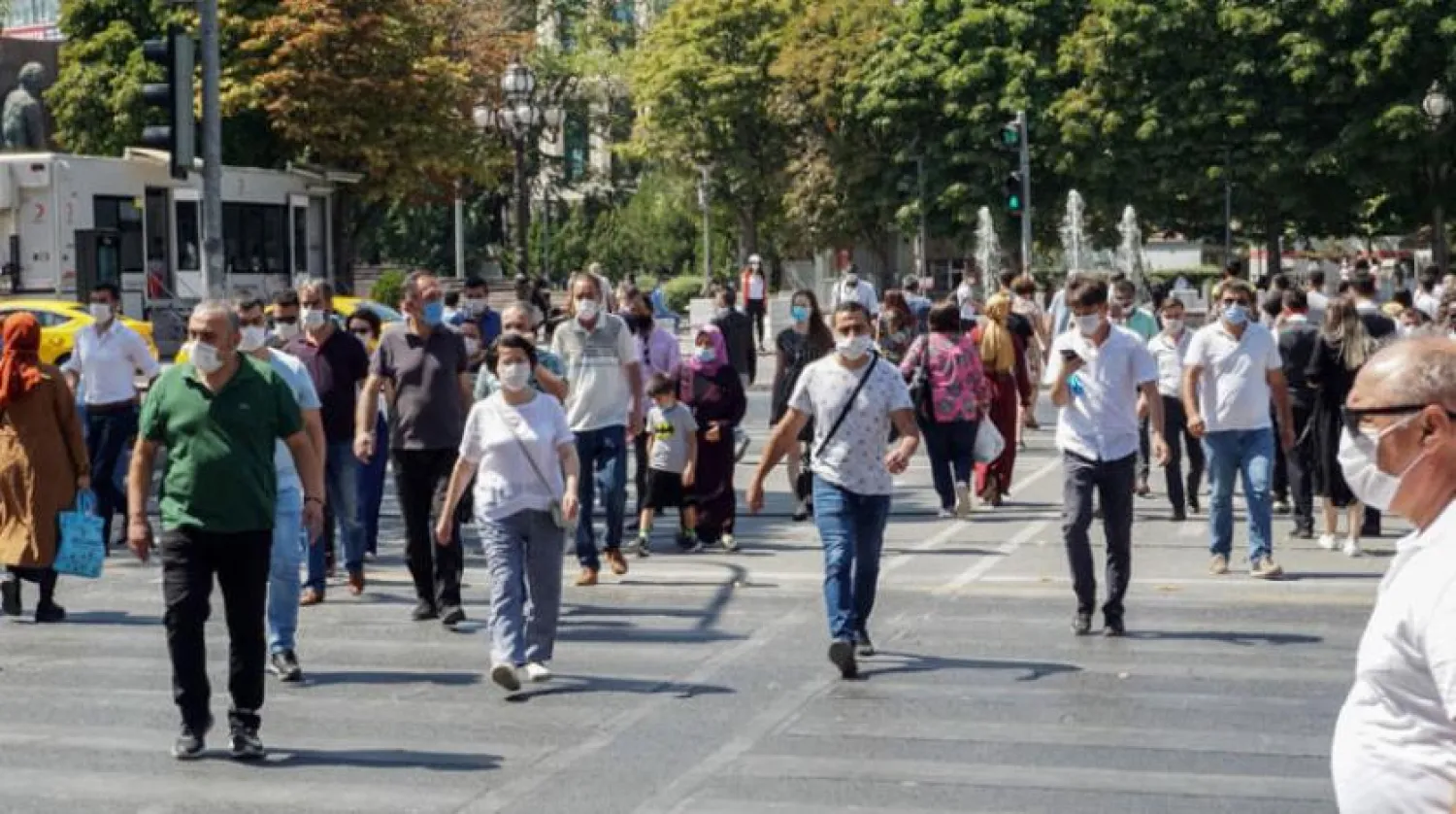 Pedestrians wear face masks as they walk in a street of Ankara on August 26, 2020, as Turkey has reported 1,502 new confirmed cases of the new coronavirus (COVID-19) - the highest daily jump in more than a month. (Photo by Adem ALTAN / AFP)