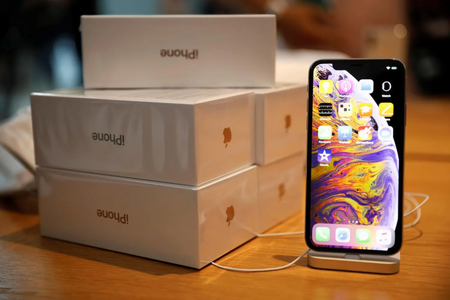 Boxes of iPhones purchased by customers are pictured next to an iPhone XS on display at the Apple Store in Singapore September 21, 2018. REUTERS/Edgar Su