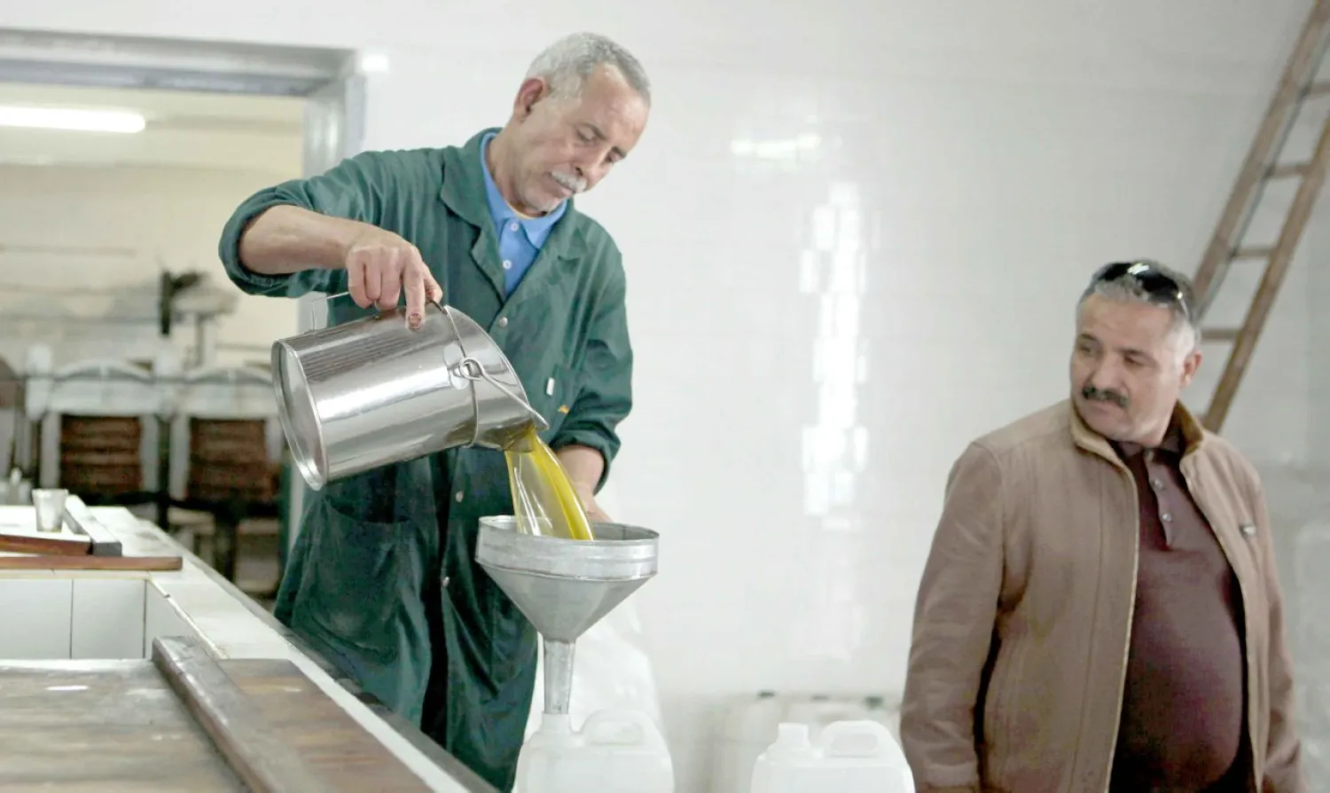 A worker pours olive oil at a traditional factory in Tebourba, 30 km from Tunis. Reuters file photo