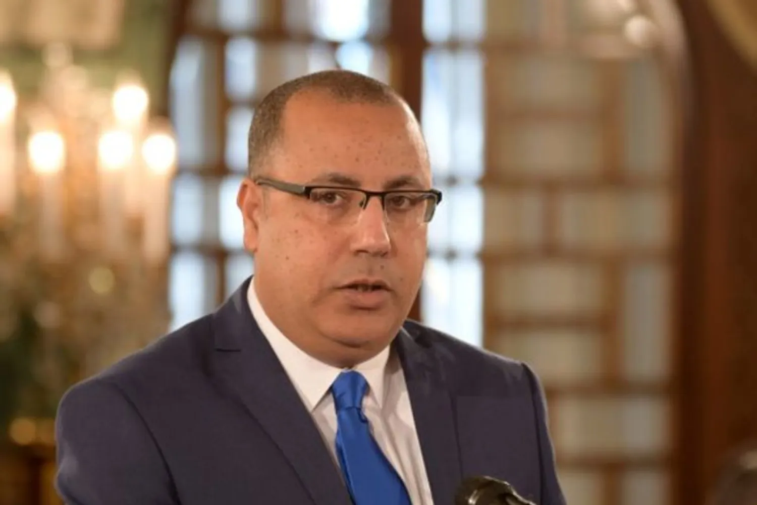Tunisian Prime Minister-designate Hisham Mechichi is shown being sworn into a previous post as interior minister outside the capital Tunis, February 27, 2020. Fethi Belaid/Pool via REUTERS/File Photo 