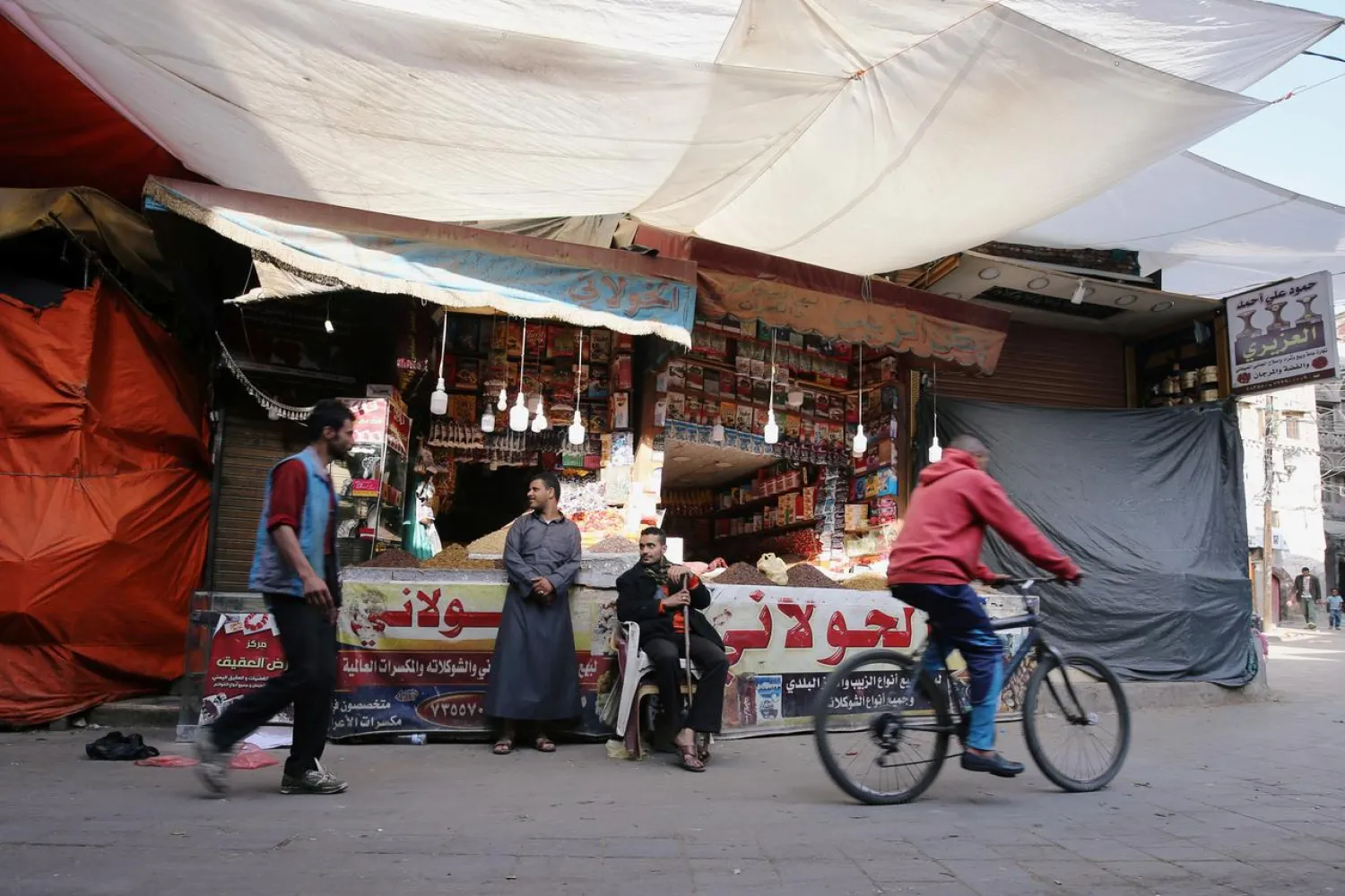 Vendors wait for customers outside their shops at a market of the old quarter of Sanaa, Yemen August 20, 2020. Picture taken August 20, 2020. REUTERS/Nusaibah Almuaalemi NO RESALES. NO ARCHIVES.
