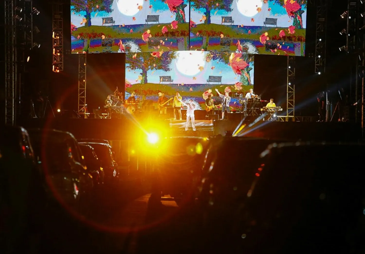 People watch a drive-in concert by local pop band Kahitna, at a parking area of the Jakarta International Expo, amid the coronavirus outbreak in Jakarta, Indonesia, August 29, 2020. (Reuters)