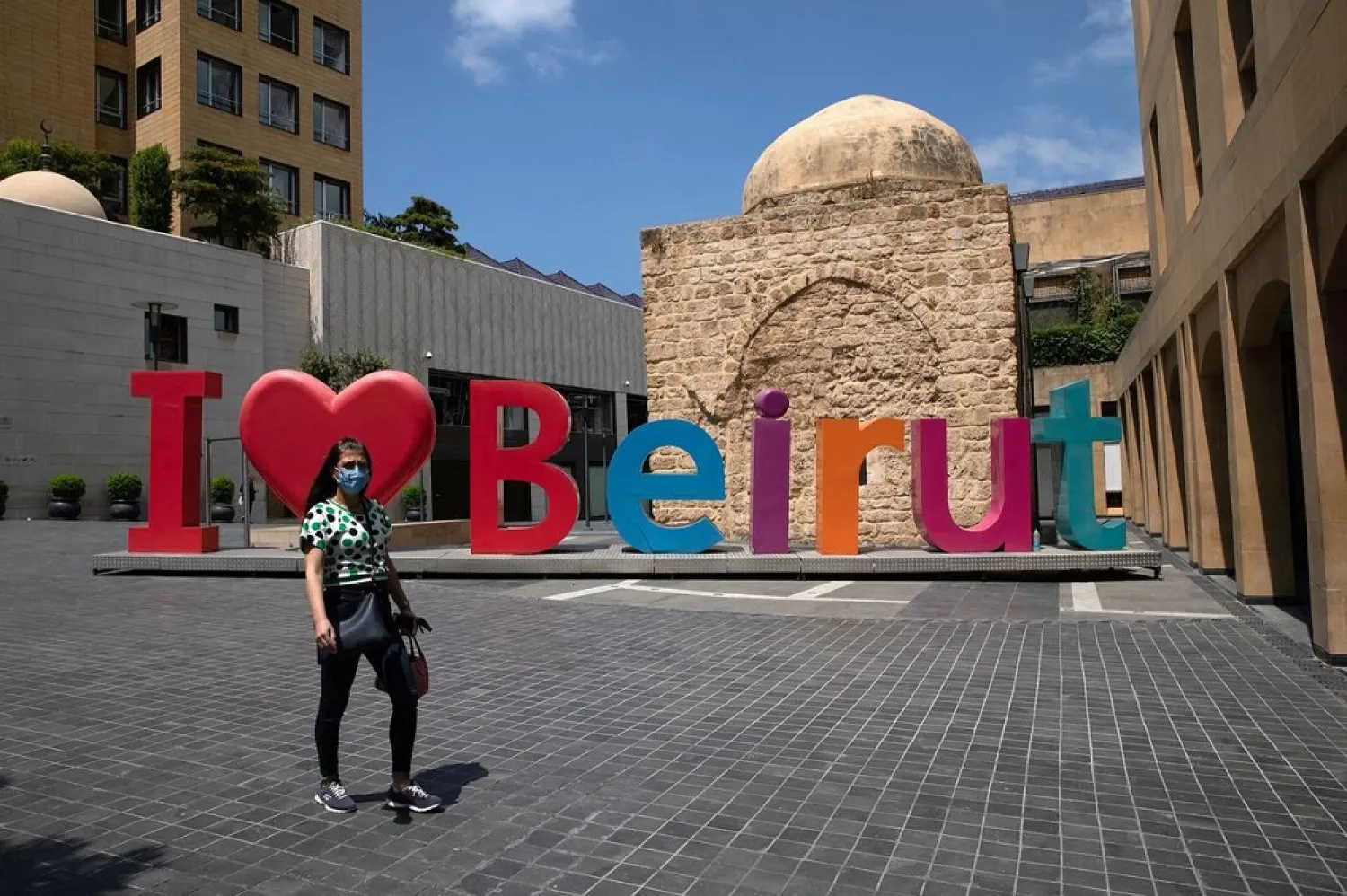 A woman walks past an ‘I love Beirut’ sign as Lebanon imposed a partial lockdown to counter the spread of the coronavirus, Lebanon August 21, 2020. (Reuters)