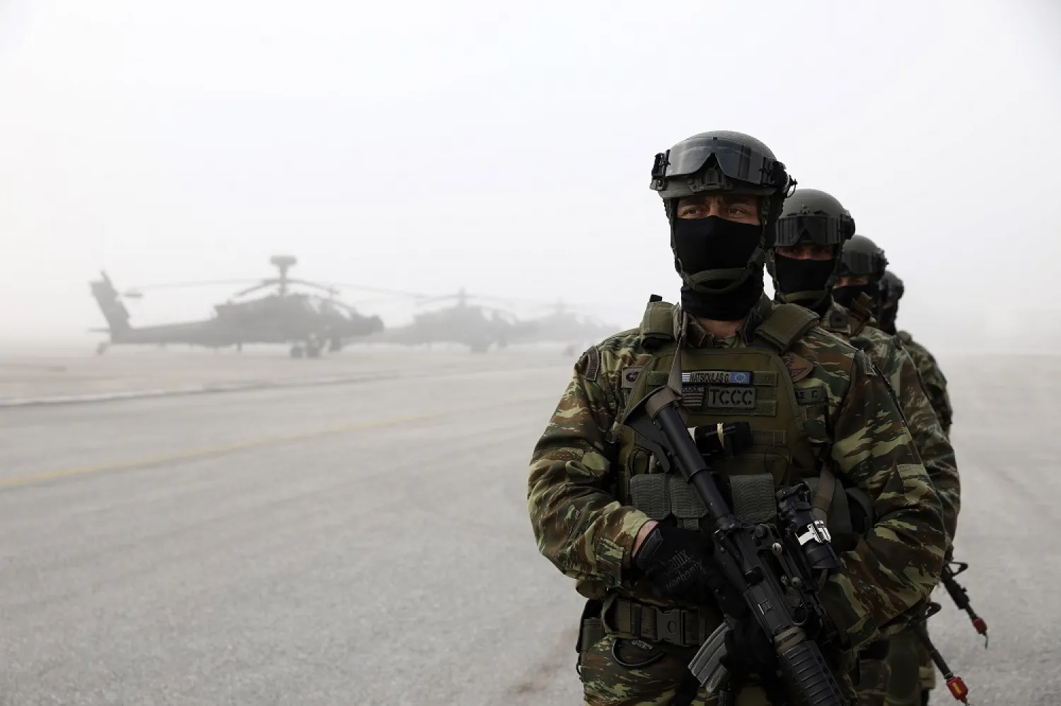 Greek marines stand near helicopters during a drill at a military base in Stefanovikio, central Greece, on Wednesday, Feb. 19, 2020. (AP)