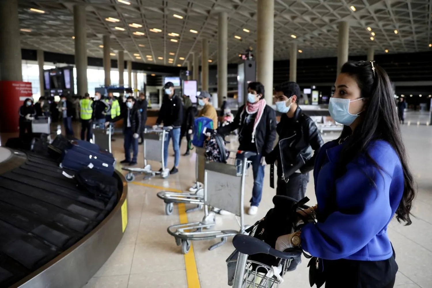 Jordanian students who were studying abroad await their luggage after returning home amid COVID-19 concerns, at Queen Alia International Airport in Amman, Jordan, May 6, 2020. (Reuters)