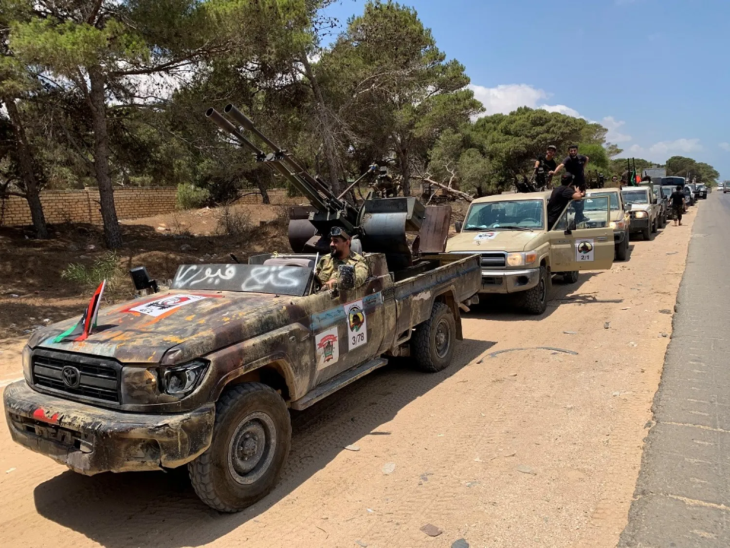 Troops loyal to the GNA are seen in military vehicles as they prepare before heading to Sirte, in Tripoli, July 6, 2020. (Reuters)
