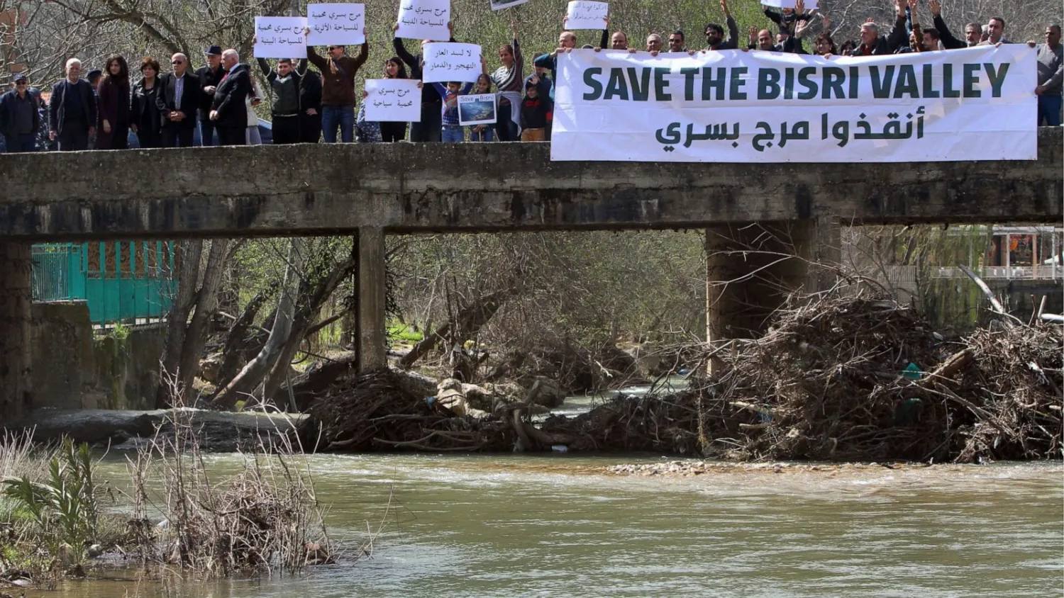 Lebanese protesters hold placards during a protest against the Bisri dam project, in the Bisri Valley, 58 kilometres southeast of Beirut, Lebanon, Sunday, March. 10, 2019. (AP Photo/Mohammed Zaatari)